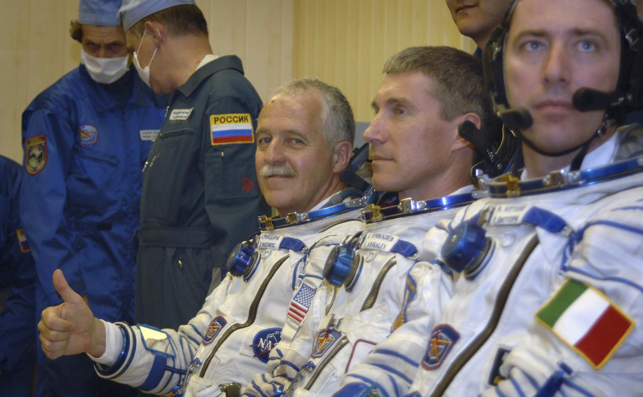 Technicians work on the Russian Sokol suits of Expedition 11 Flight Engineer and NASA Science Officer John Phillips, far left, and Commander Sergei Krikalev and European Space Agency astronaut Roberto Vittori, of Italy, right, prior to launch aboard the Soyuz TMA-6 spacecraft at the Baikonur Cosmodrome in Baikonur, Kazakhstan, Friday, April 15, 2005 for a two-day trip to the International Space Station. Photo Credit: (NASA/Bill Ingalls)