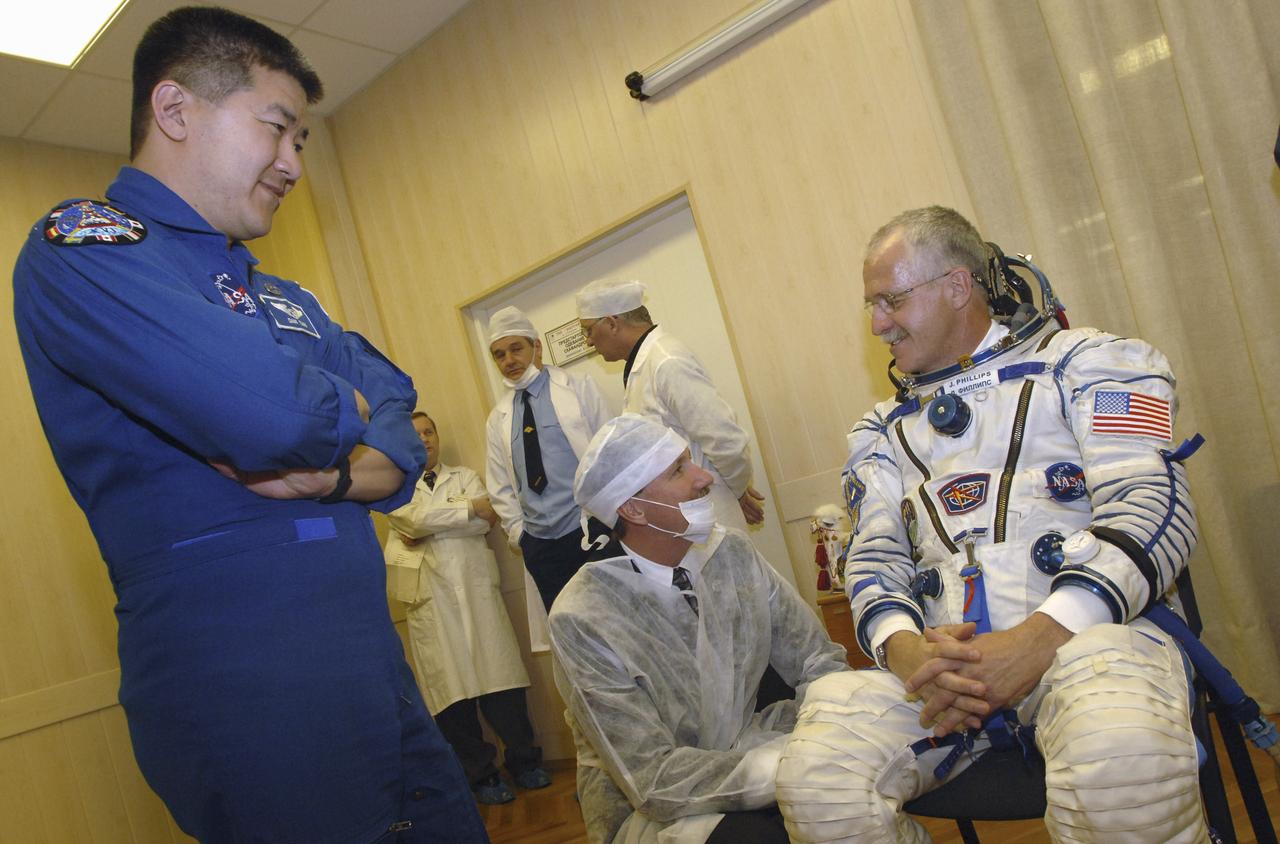 NASA's Chief Astronaut Kent Rommenger and Expedition 11 backup Dan Tani, left, talk with Expedition 11 Flight Engineer and NASA Science Officer John Phillips, seated, prior to launch aboard the Soyuz TMA-6 spacecraft from the Baikonur Cosmodrome in Kazakhstan, Friday, April 15, 2005, for a two-day trip to the International Space Station. Photo Credit: (NASA/Bill Ingalls)