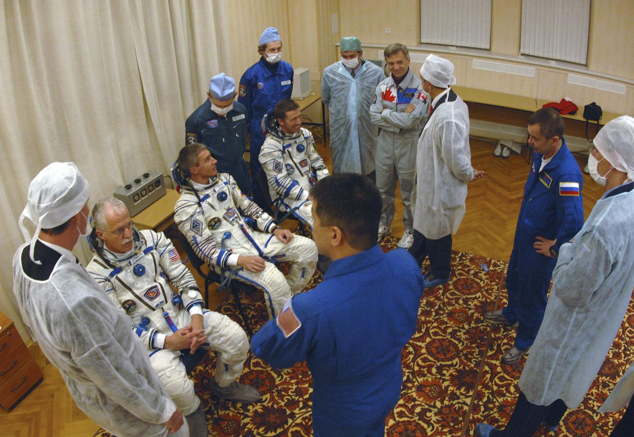 Expedition 11 Commander Sergei Krikalev, seated center, Flight Engineer and NASA Science Officer John Phillips, seated left and European Space Agency Astronaut Roberto Vittori, of Italy, seated right, relax prior to launch aboard the Soyuz TMA-6 spacecraft from the Baikonur Cosmodrome in Kazakhstan, Friday, April 15, 2005 for a two-day trip to the International Space Station. Photo Credit: (NASA/Bill Ingalls)