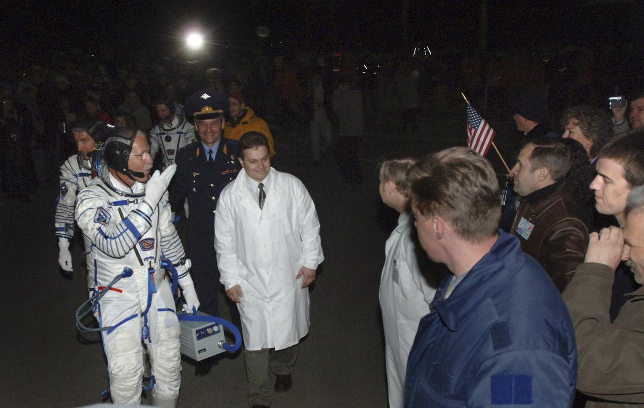 NASA Astronaut John Phillips blows a kiss goodbye to his family as the Expedition 11 crew boards the bus to that will took them to the launch pad, Friday, April 15, 2005, at the Baikonur Cosmodrome in Kazakhstan. Expedition 11 Commander Sergei Krikalev, Phillips and European Space Agency Astronaut Roberto Vittori of Italy launched aboard the Soyuz TMA-6 spacecraft for a two-day trip to the International Space Station. Krikalev and Phillips will spend six months on the Station, replacing Expedition 10 Commander Leroy Chiao and Flight Engineer Salizhan Sharipov, while Vittori will spend eight days on the Station under a commercial contract between ESA and the Russian Federal Space Agency, returning to Earth with Chiao and Sharipov on April 25. Photo Credit: (NASA/Bill Ingalls)