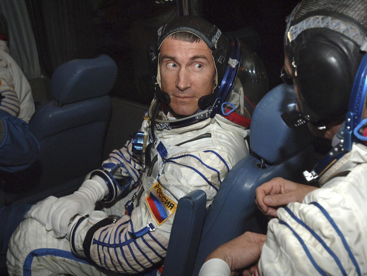 Expedition 11 Commander Sergei Krikalev, left and Flight Engineer and NASA Science Officer John Phillips talk during a bus ride prior to launch, Friday, April 15, 2005 at the Baikonur Cosmodrome in Kazakhstan. Photo Credit: (NASA/Bill Ingalls)