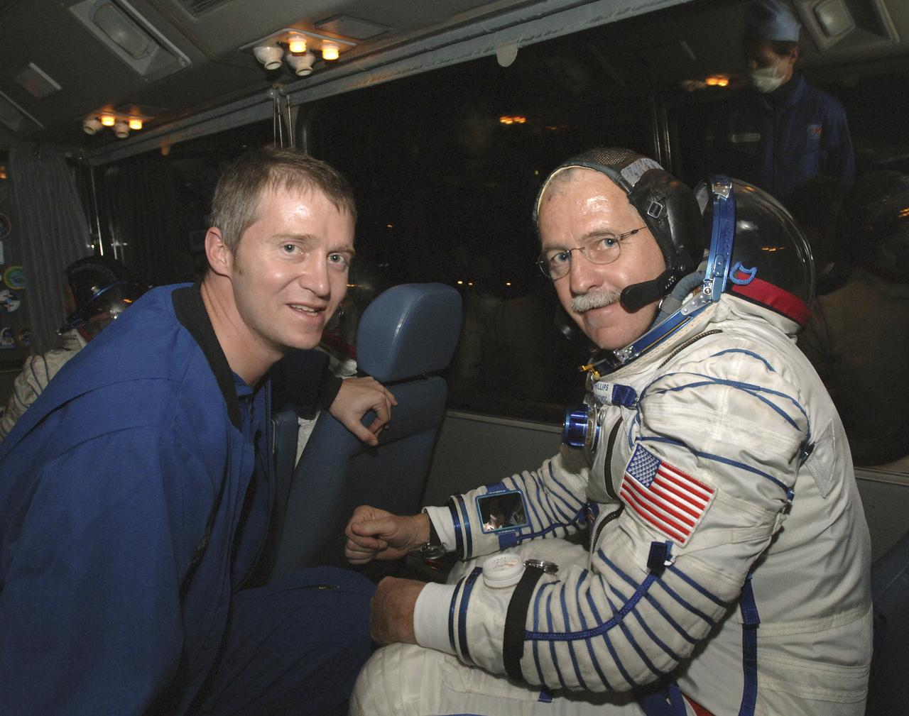 NASA Flight Surgeon Jim Locke is seen with Flight Engineer and NASA Science Officer John Phillips during a bus ride prior to launch, Friday, April 15, 2005 at the Baikonur Cosmodrome in Kazakhstan. Photo Credit: (NASA/Bill Ingalls)