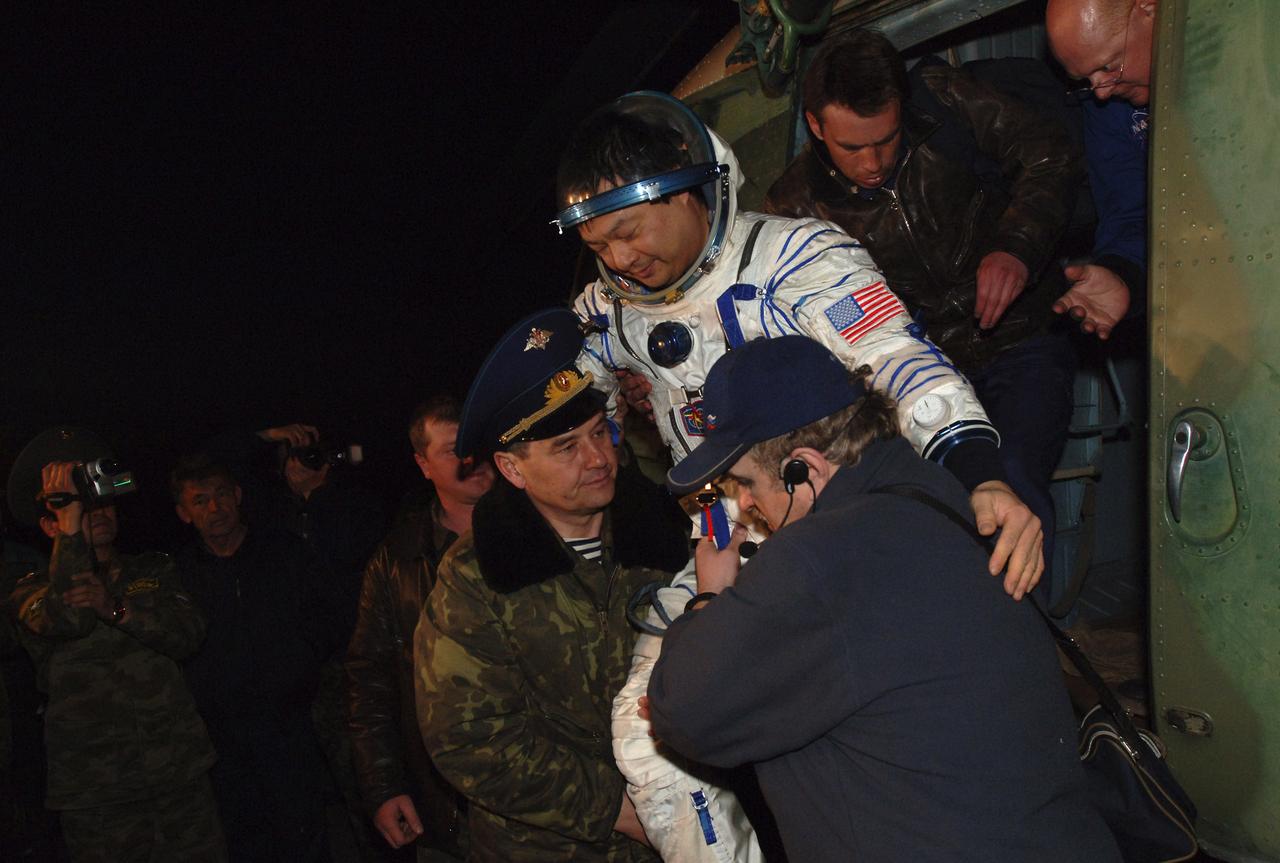 Expedition 10 Commander Leroy Chiao is carried off a Russian search and rescue helicopter after a pre-dawn landing in the Soyuz TMA-5 capsule Monday, April 25, 2005 northeast of the town of Arkalyk, Kazakhstan.  Chiao and Expedition 10 Flight Engineer Salizhan Sharipov wrapped up a six-month mission aboard the International Space Station, while European Space Agency astronaut Roberto Vittori completed a ten-day mission aboard the ISS under a commercial contract between ESA and the Russian Federal Space Agency.  Photo Credit: (NASA/Bill Ingalls)