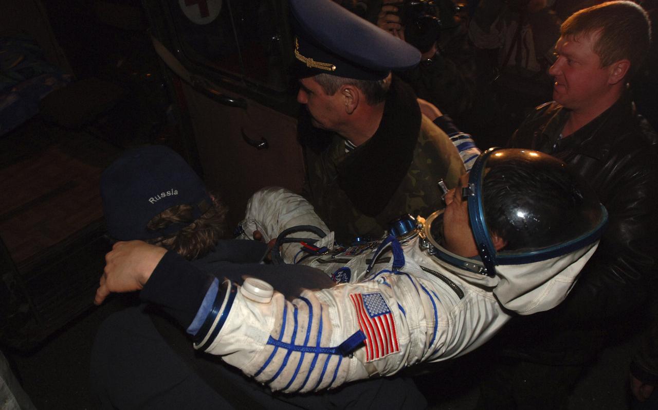 Expedition 10 Commander Leroy Chiao is carried onto a Russian transport vehicle after a pre-dawn landing in the Soyuz TMA-5 capsule Monday, April 25, 2005 northeast of the town of Arkalyk, Kazakhstan.  Chiao and Expedition 10 Flight Engineer Salizhan Sharipov wrapped up a six-month mission aboard the International Space Station, while European Space Agency astronaut Roberto Vittori completed a ten-day mission aboard the ISS under a commercial contract between ESA and the Russian Federal Space Agency.  Photo Credit: (NASA/Bill Ingalls)