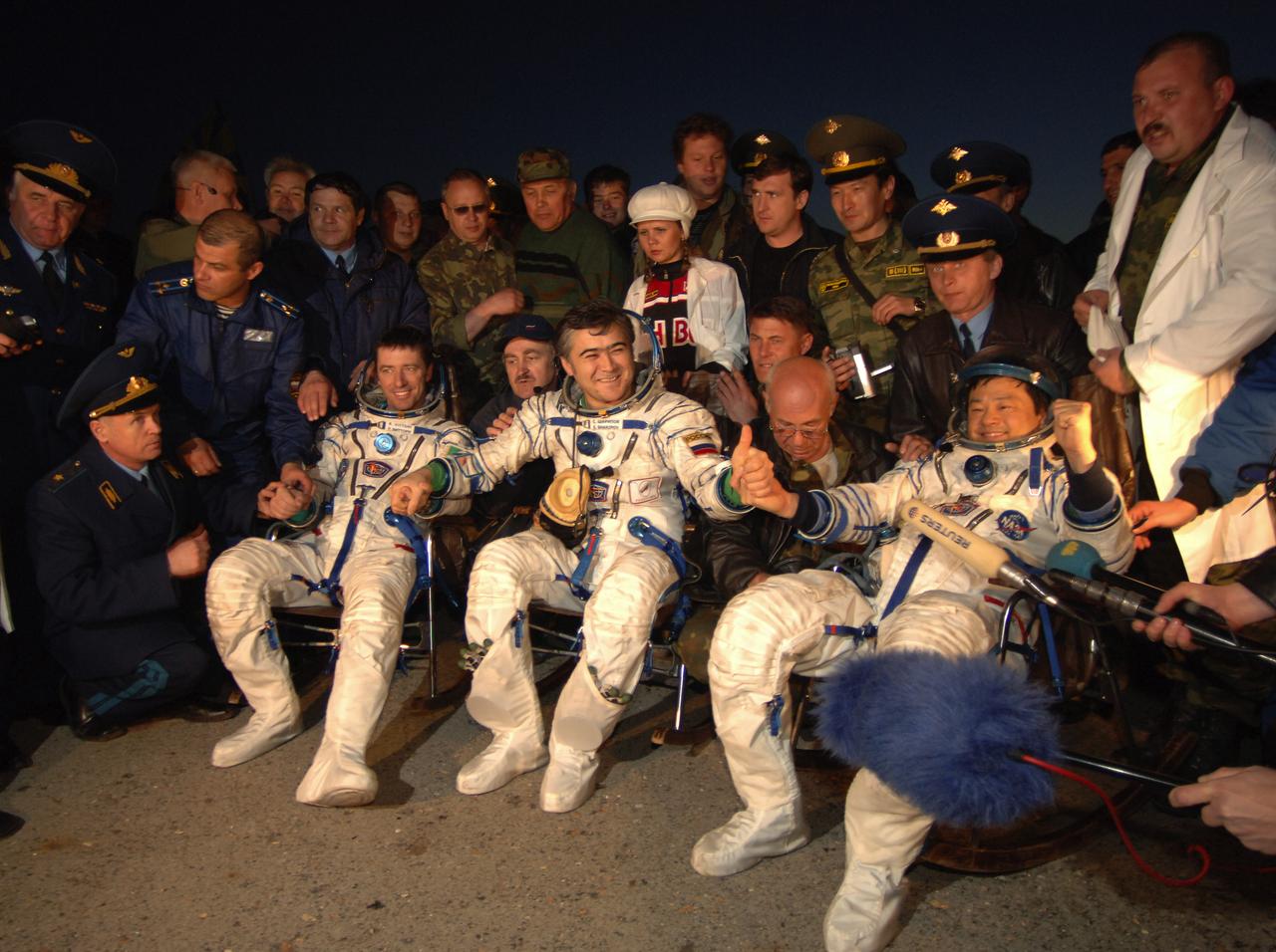 Expedition 10 Commander Leroy Chiao, right, Flight Engineer Salizhan Sharipov and European Space Agency astronaut Roberto Vittori brought their Soyuz TMA-5 capsule to a pre-dawn landing on Monday, April 25, 2005 northeast of the town of Arkalyk in Kazakhstan to wrap up a six-month mission aboard the International Space Station for Chiao and Sharipov.  Vittori completed a ten-day mission aboard the ISS under a commercial contract between ESA and the Russian Federal Space Agency.  Photo Credit: (NASA/Bill Ingalls)