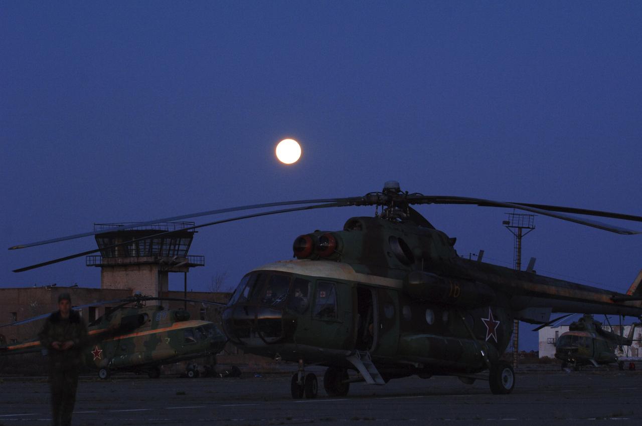 A Russian search and rescue helicopter waits to take a member of the Expedition 10 crew to Kustanay, Kazakshtan from Arkalyk, Monday, April, 25, 2005. Expedition 10 Commander Leroy Chiao, Flight Engineer Salizhan Sharipov and European Space Agency astronaut Roberto Vittori brought their Soyuz TMA-5 capsule to a pre-dawn landing April 25 northeast of the town of Arkalyk to wrap up a six-month mission aboard the International Space Station for Chiao and Sharipov, and a ten-day mission for Vittori, who flew under a commercial contract between ESA and the Russian Federal Space Agency. Photo Credit: (NASA/Bill Ingalls)