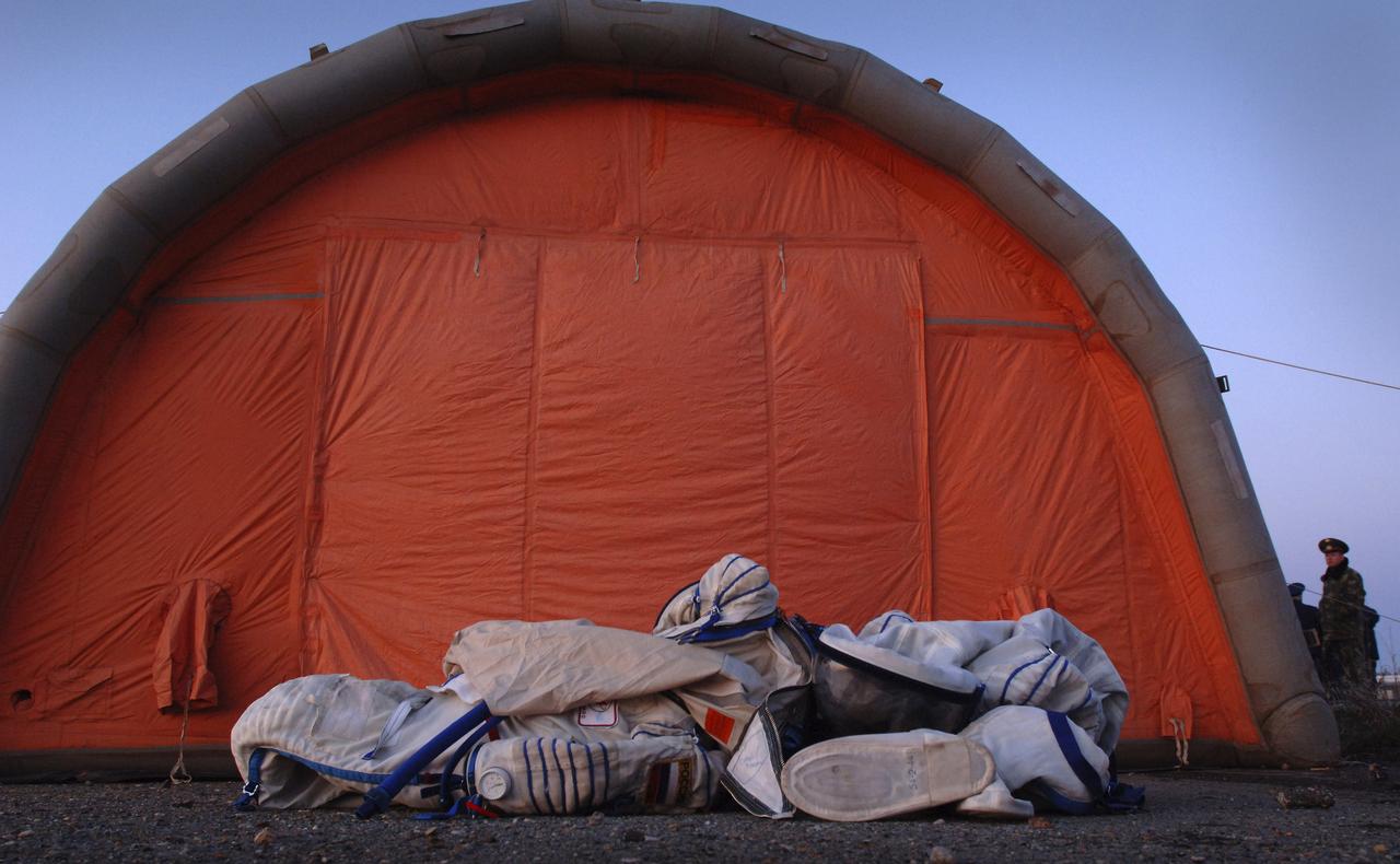 Russian flight suits lie on the ground outside the inflatable medical tent, Monday, April 25, 2005, Arkalyk, Kazakhstan. Expedition 10 Commander Leroy Chiao, Flight Engineer Salizhan Sharipov and European Space Agency astronaut Roberto Vittori brought their Soyuz TMA-5 capsule to a pre-dawn landing April 25 northeast of the town of Arkalyk in Kazakhstan to wrap up a six-month mission aboard the International Space Station for Chiao and Sharipov, and a ten-day mission for Vittori, who flew under a commercial contract between ESA and the Russian Federal Space Agency. Photo Credit: (NASA/Bill Ingalls)