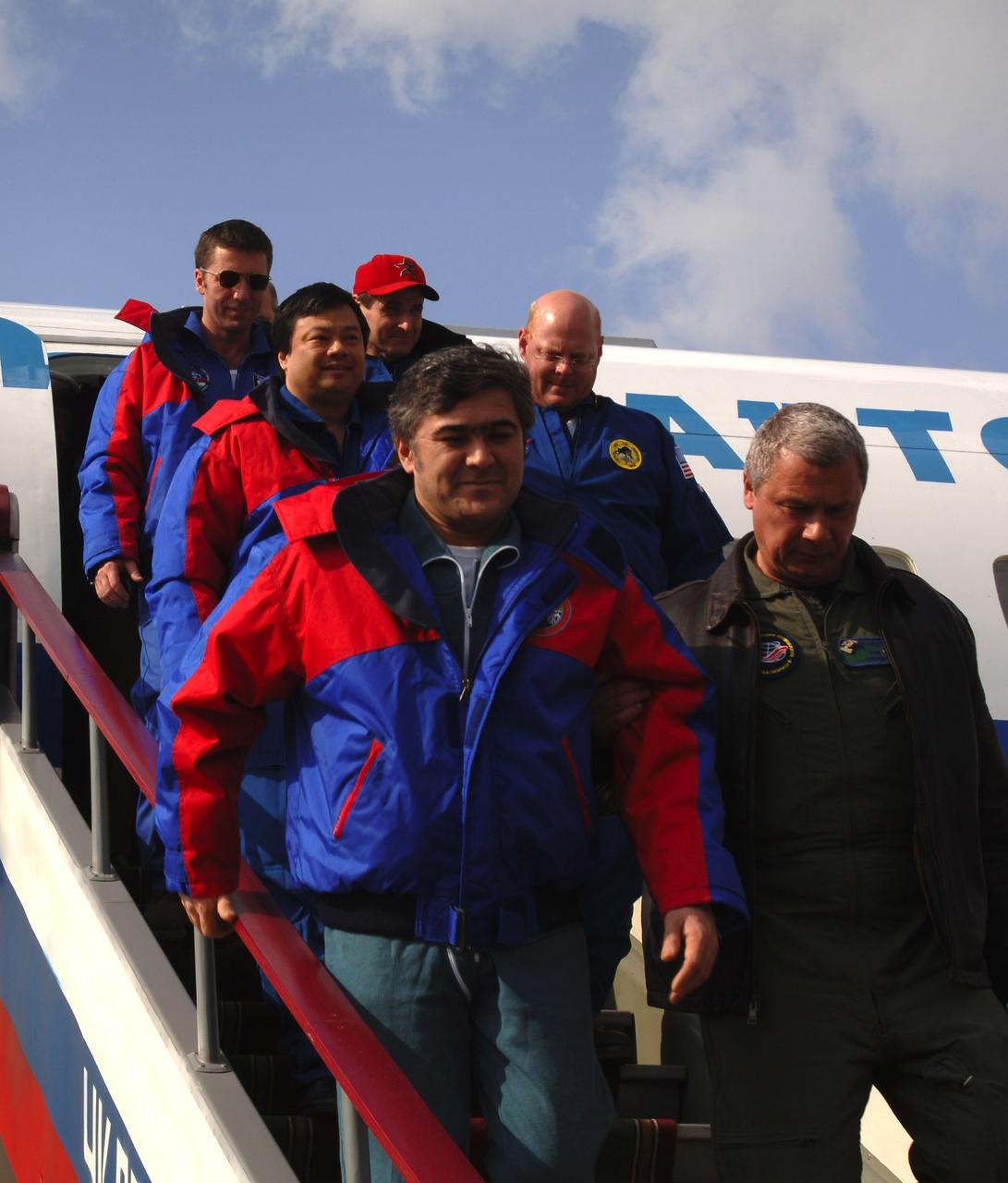 Flight Engineer Salizhan Sharipov, bottom left, Expedition 10 Commander Leroy Chiao and European Space Agency astronaut Roberto Vittori, top left, arrive in Star City, Russia, Monday, April 25, 2005, after thet brought their Soyuz TMA-5 capsule to a pre-dawn landing northeast of Arkalyk, Kazakhstan.  Photo Credit: (NASA/Bill Ingalls) 
