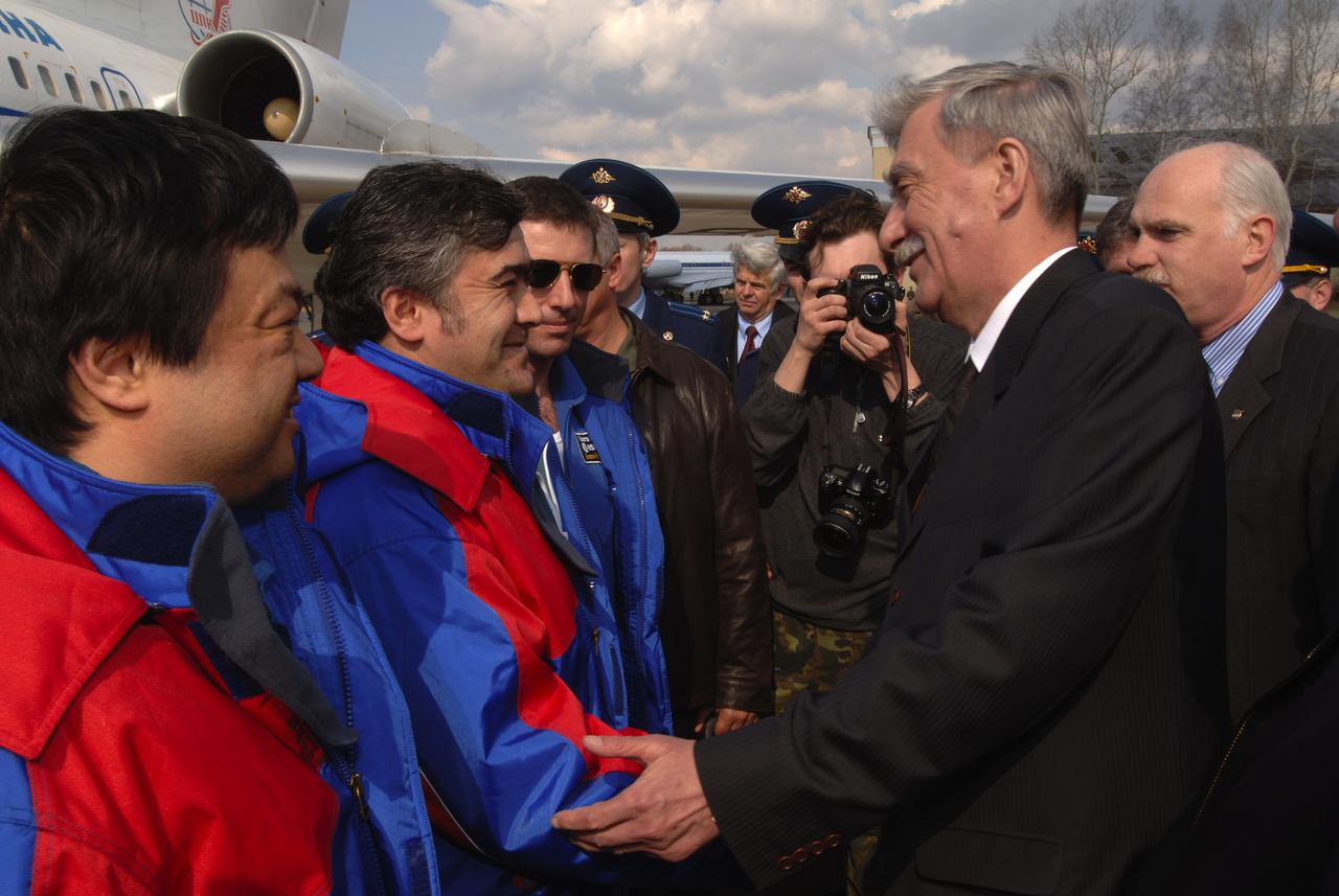 Expedition 10 Commander Leroy Chiao, far left, Flight Engineer Salizhan Sharipov and European Space Agency astronaut Roberto Vittori, third from left, are welcomed home by officials at Star City, Russia, Monday, April 25, 2005.  The crew brought their Soyuz TMA-5 capsule to a pre-dawn landing April 25 northeast of the town of Arkalyk to wrap up a six-month mission aboard the International Space Station for Chiao and Sharipov, and a ten-day mission for Vittori, who flew under a commercial contract between ESA and the Russian Federal Space Agency.  Photo Credit: (NASA/Bill Ingalls)