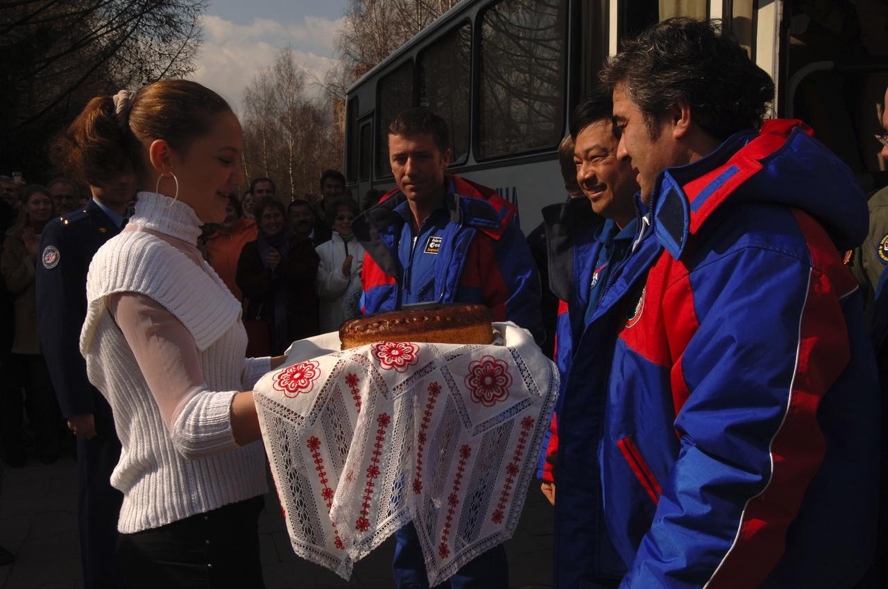 Expedition 10 Flight Engineer Salizhan Sharipov, far right, Expedition 10 Commander Leroy Chiao and European Space Agency astronaut Roberto Vittori, third from right, are treated to a traditional salt and bread welcoming at Star City, Russia, Monday, April 25, 2005.  The crew brought their Soyuz TMA-5 capsule to a pre-dawn landing April 25 northeast of the town of Arkalyk in Kazakhstan to wrap up a six-month mission aboard the International Space Station for Chiao and Sharipov, and a ten-day mission for Vittori, who flew under a commercial contract between ESA and the Russian Federal Space Agency.  Photo Credit: (NASA/Bill Ingalls)