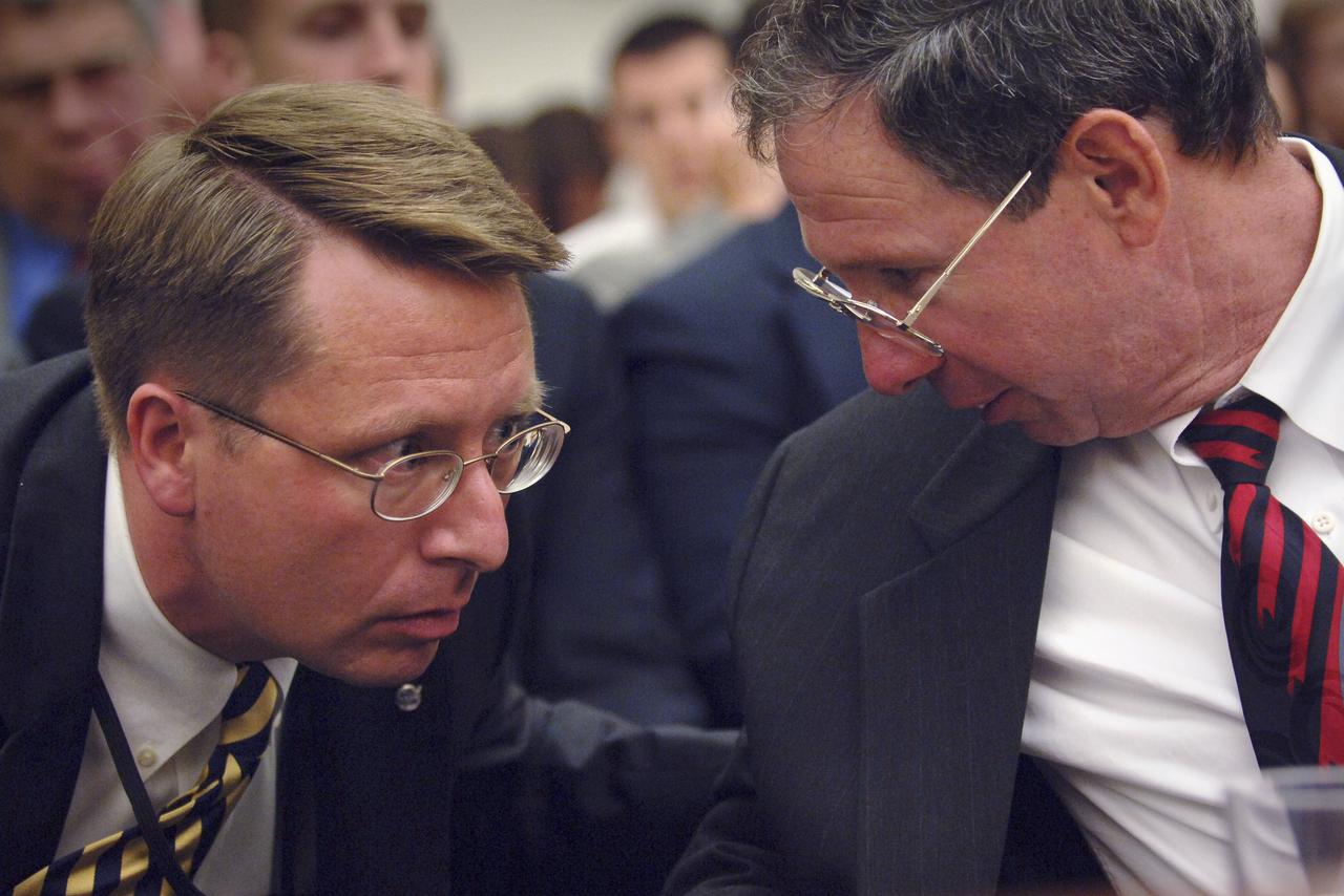 NASA Special Assistant Mr. Christopher Shank, left, and NASA Administrator Michael Griffin talk during a hearing before the House Science Committee, Tuesday,  June 28, 2005, Rayburn House Office building, Washington.  Photo Credit: (NASA/Bill Ingalls)