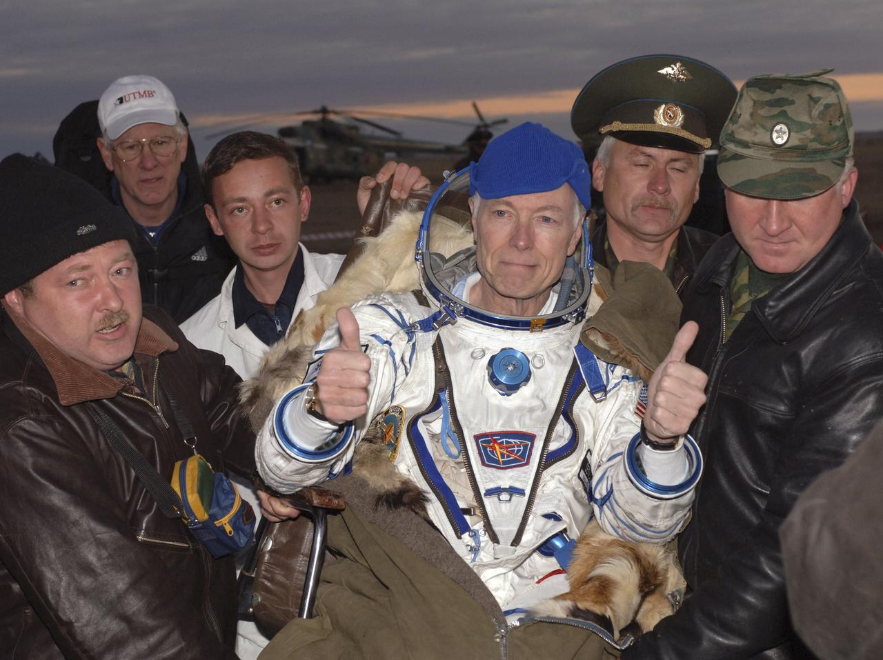 American businessman Greg Olsen gives a thumbs up after returning to earth aboard a Soyuz spacecraft, Tuesday, Oct. 11, 2005, near Arlalyk, Kazakhstan with Expedition 11 crew members cosmonaut Sergei Krikalev and NASA astronaut John Phillips. Olsen spent more than a week on the International Space Station and Phillips and Kiralev had a six-month mission. Photo Credit: (NASA/Bill Ingalls)