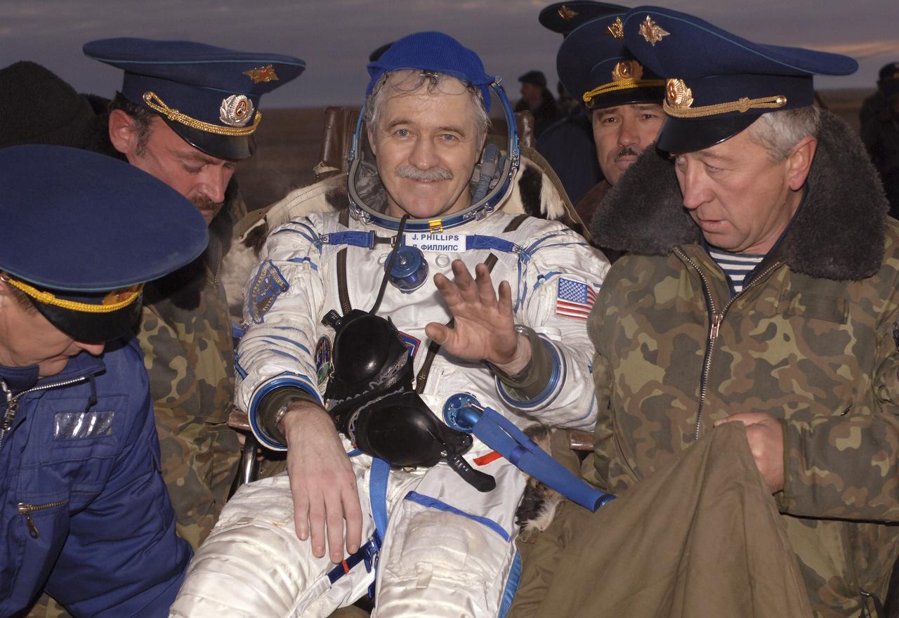 Expedition 11 astronaut John Phillips smiles after landing, Tuesday, Oct. 11, 2005, near Arlalyk, Kazakhstan. Phillips and Expedition 11 cosmonaut Sergei Krikalev, landed after a six-month mission in orbit. Along with American businessman Greg Olsen, who visited the station for more than a week, Phillips and Krikalev returned to Earth aboard a Russian Soyuz spacecraft. Photo Credit: (NASA/Bill Ingalls)