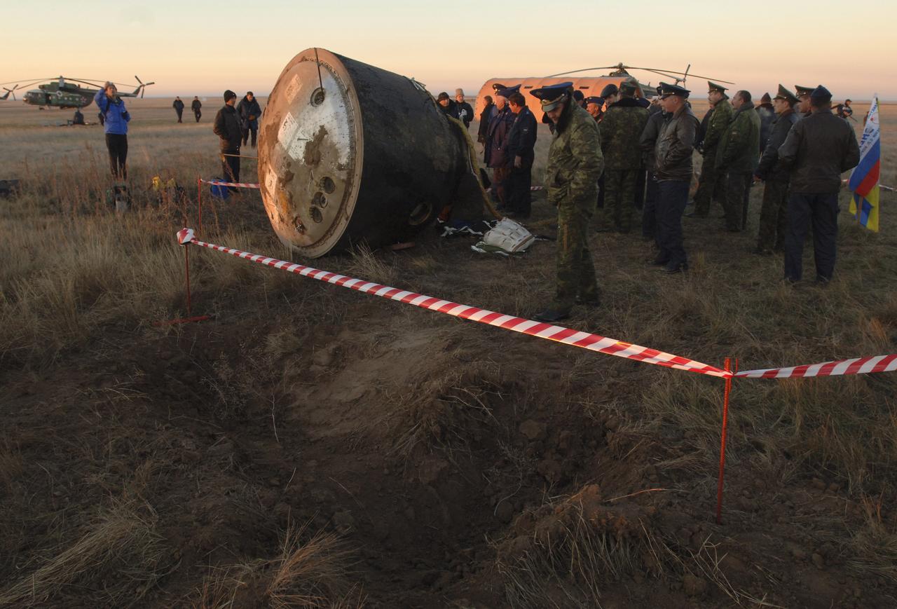 Divits made by the landing jets of the Soyuz capsule, background, are seen after touchdown, Tuesday, Oct. 11, 2005, near Arlalyk, Kazakhstan. Members of the 11th expedition to the international space station, astronaut John Phillips and cosmonaut Sergei Krikalev landed after a six-month mission in orbit. Along with American businessman Greg Olsen, who visited the station for more than a week, Phillips and Krikalev returned to Earth aboard a Russian Soyuz spacecraft. Photo Credit: (NASA/Bill Ingalls)