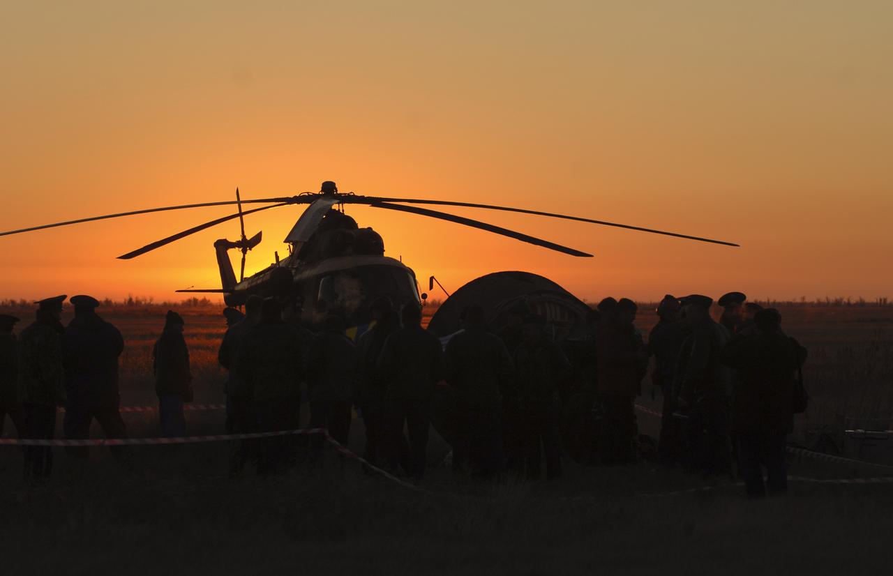 A helicopter is silouhetted in the early morning sunlight awaiting transport of members of the 11th expedition to the international space station, Astronaut John Phillips and Cosmonaut Sergei Krikalev, following their touchdown near Arlalyk, Kazakhstan, Tuesday, Oct. 11, 2005. Along with American businessman Greg Olsen, who visited the station for more than a week, Phillips and Krikalev returned to Earth aboard a Russian Soyuz spacecraft. Photo Credit: (NASA/Bill Ingalls)