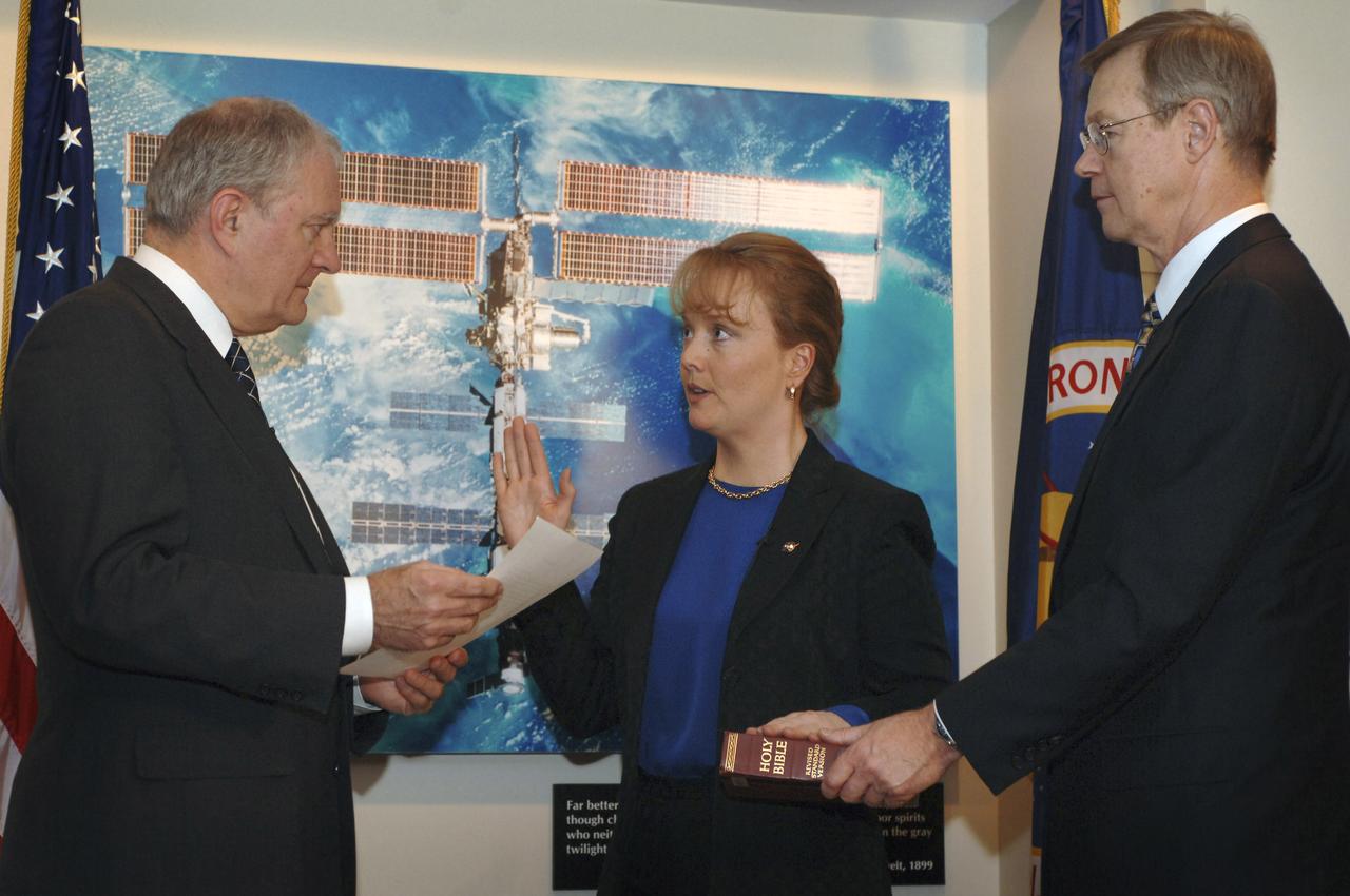 Shana Dale, center, is sworn in as NASA's deputy administrator by Dr. John H. Marburger, left, Director, Office of Science and Technology Policy (OSTP), Executive Office of the President, Tuesday, Nov. 29, 2005, at NASA Headquarters in Washington. With Ms. Dale is Mr. Mike Fagan. Photo Credit: (NASA/Bill Ingalls)