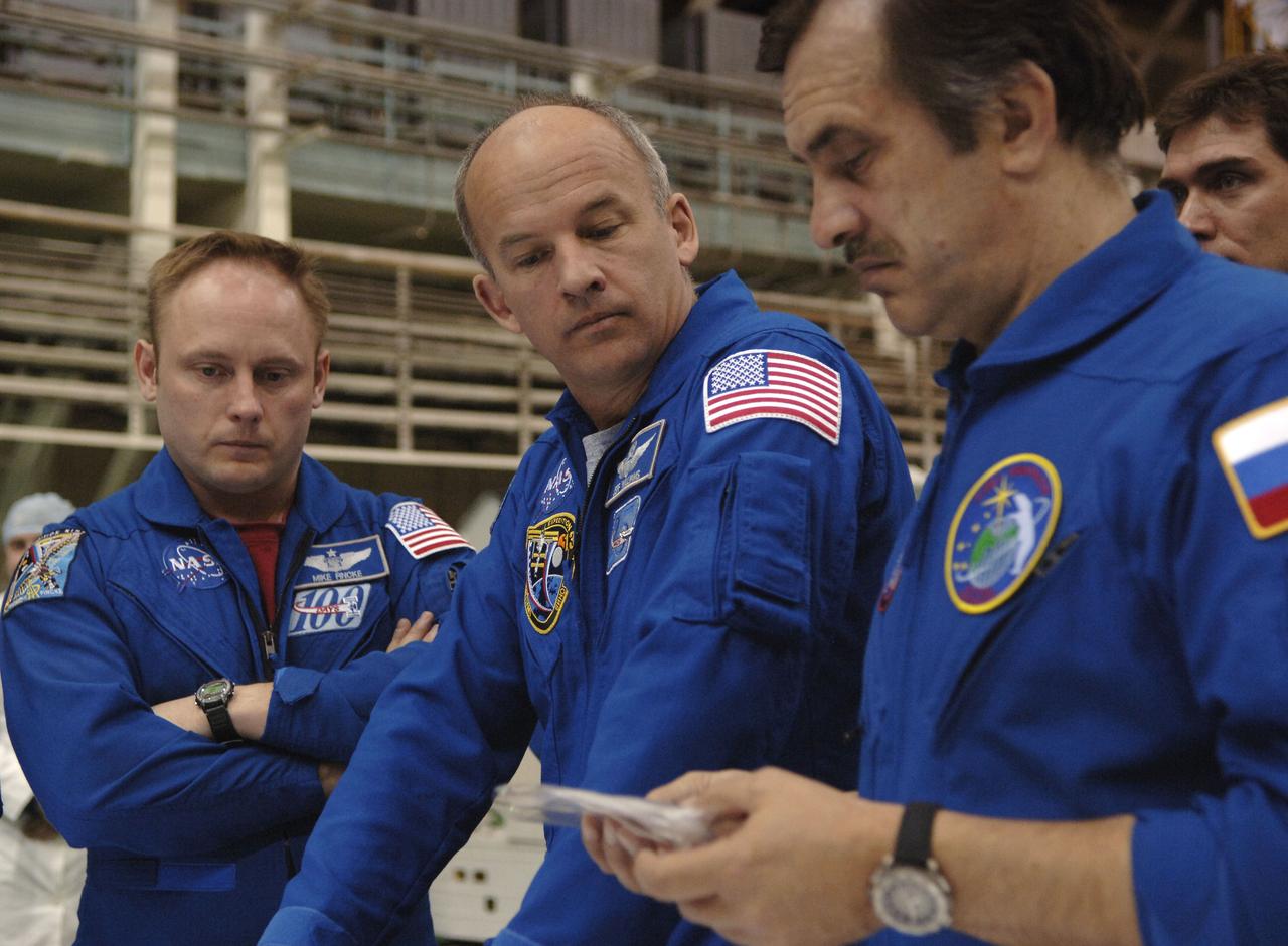 Expedition 13 backup crew member Michael Fincke, left, Jeffrey N. Williams, Expedition 13 Science Officer and Flight Engineer, and Pavel V. Vinogradov, right, Commander, go over final review of Soyuz equipment at building 254 of the Baikonur Cosmodrome in Baikonur, Kazakhstan days before their launch to the International Space Station. Sunday, March 26, 2006. Photo Credit: (NASA/Bill Ingalls)