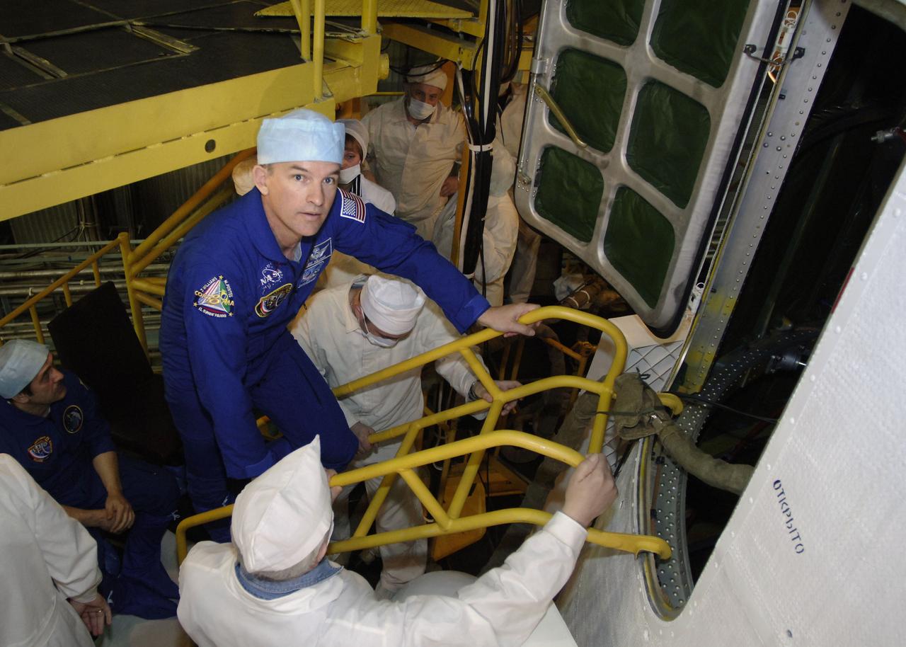 Expedition 13 Science Officer and Flight Engineer Jeffrey N. Williams climbs into the Soyuz capsule for his final check at building 254 of the Baikonur Cosmodrome in Baikonur, Kazakhstan. Sunday, March 26, 2006. Photo Credit: (NASA/Bill Ingalls)