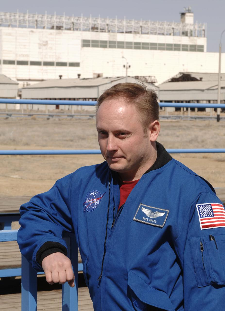 Expedition 13 backup crew member Michael Fincke relaxes outside of building 254 of the Baikonur Cosmodrome in Baikonur, Kazakhstan. The Expedition 13 prime and backup crews were at building 254 for the final check of the Soyuz spacecraft. Sunday, March 26, 2006. Photo Credit: (NASA/Bill Ingalls)