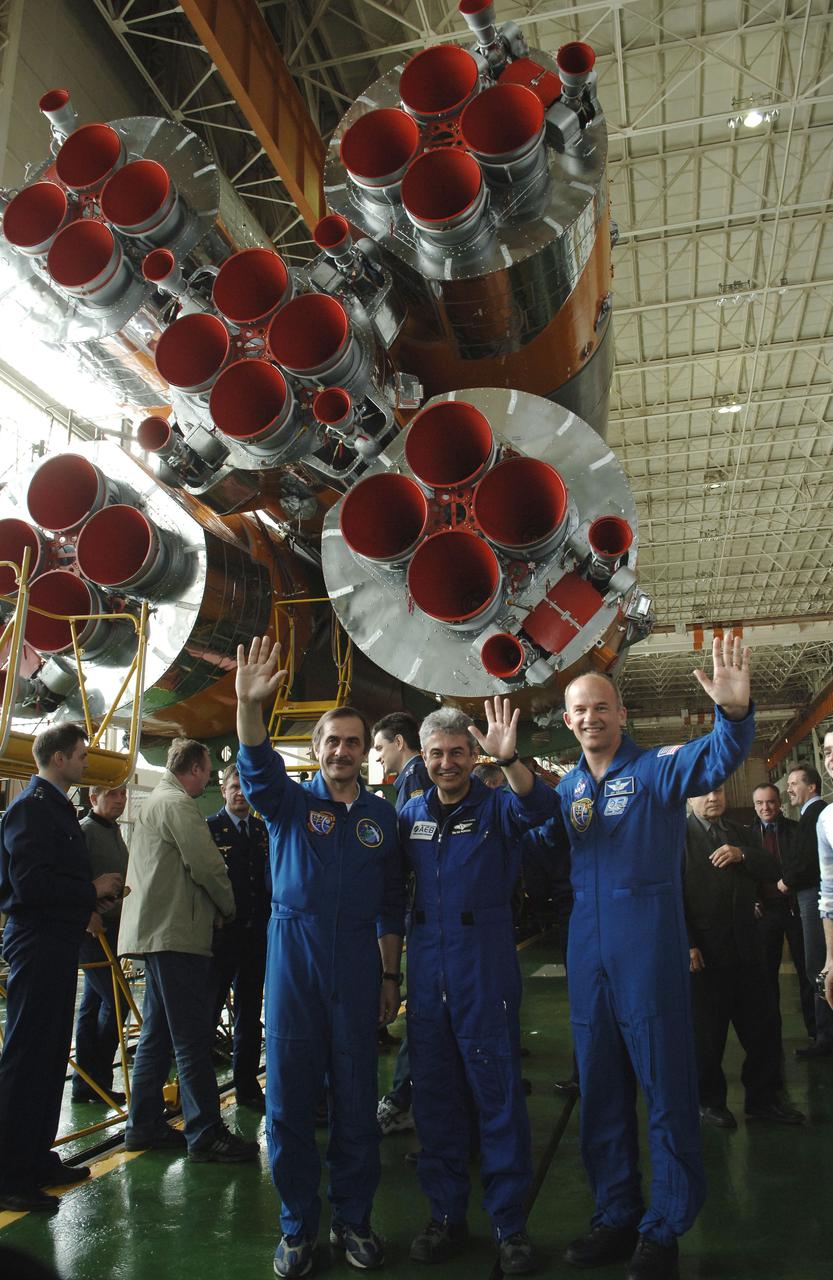 Pavel V. Vinogradov, right, Russia’s Federal Space Agency Expedition 13 International Space Station Commander; Marcos Pontes, Brazilian Space Agency Soyuz crew member; and Jeffrey N. Williams, left, Expedition 13 Science Officer and Flight Engineer, waves at media representatives during a tour of the Soyuz assembly building at the Baikonur Cosmodrome in Baikonur, Kazakhstan. Sunday, March 26, 2006. Photo Credit: (NASA/Bill Ingalls)