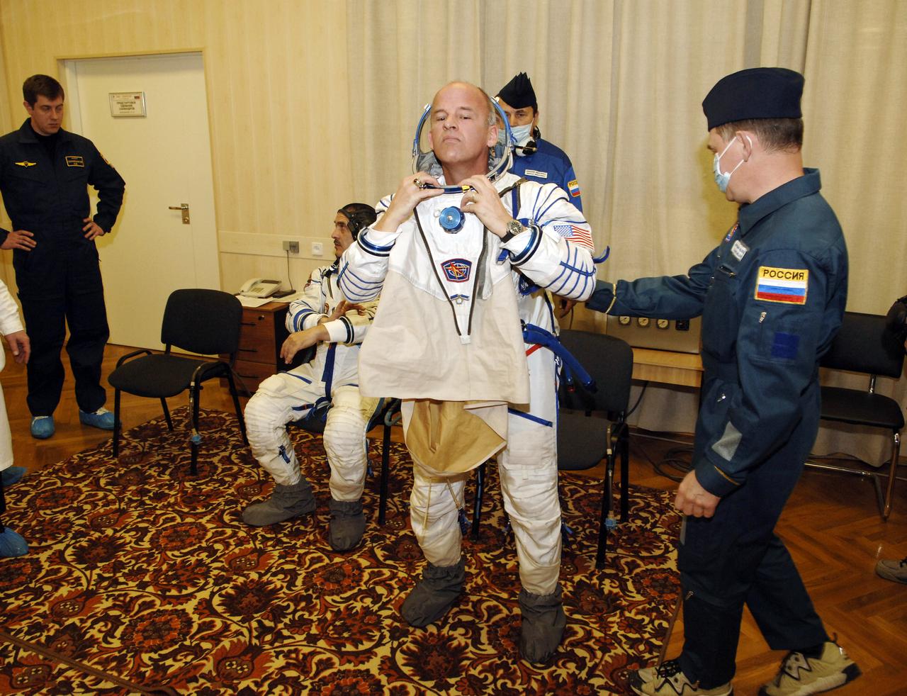 Expedition 13 Science Officer and Flight Engineer Jeffrey N. Williams dons his pressure suit at building 254 of the Baikonur Cosmodrome in Baikonur, Kazakhstan, Thursday, March 30, 2006 prior to launch onboard the Soyuz spacecraft. Photo Credit: (NASA/Bill Ingalls)