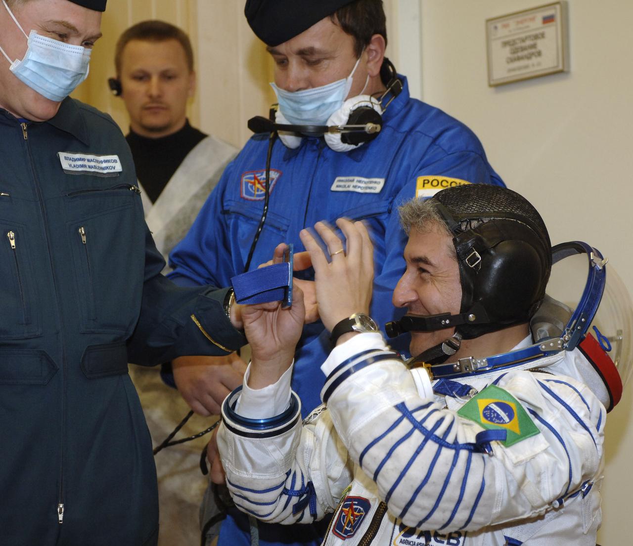 Marcos Pontes, Brazilian Space Agency Soyuz crew member, looks into a mirror to check his hair after donning his pressure suit in preparation to launch onboard the Soyuz spacecraft from Baikonur, Kazakhstan, Thursday, March 30, 2006. Photo Credit: (NASA/Bill Ingalls)