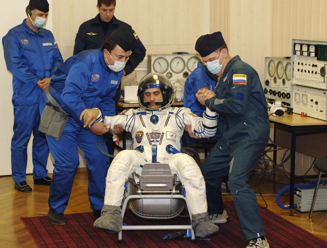 Technicians check suit pressure for Expedition 13 Commander Pavel V. Vinogradov prior to launch onboard the Soyuz spacecraft from Baikonur, Kazakhstan, Thursday, March 30. 2006. Photo Credit: (NASA/Bill Ingalls)