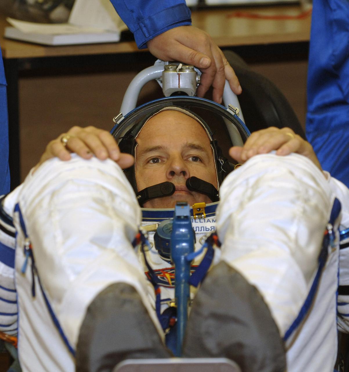 Technicians check suit pressure for Expedition 13 Science Officer and Flight Engineer Jeffrey N. Williams prior to launch onboard the Soyuz spacecraft from Baikonur, Kazakhstan, Thursday, March 30. 2006. Photo Credit: (NASA/Bill Ingalls)