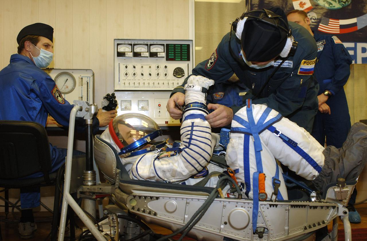 Technicians check suit pressure for Expedition 13 Science Officer and Flight Engineer Jeffrey N. Williams prior to launch onboard the Soyuz spacecraft from Baikonur, Kazakhstan, Thursday, March 30. 2006. Photo Credit: (NASA/Bill Ingalls)