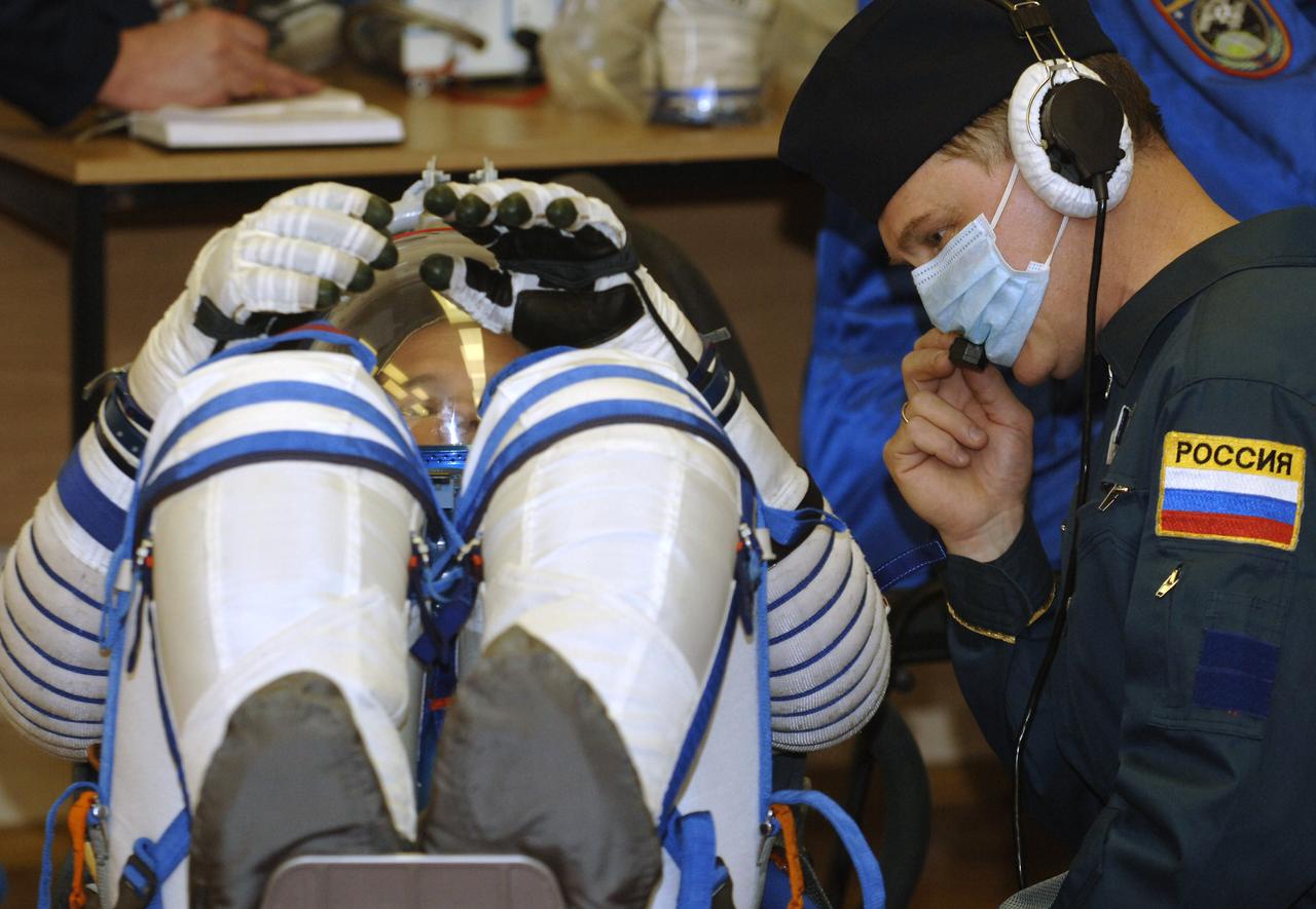 Technicians check suit pressure for Expedition 13 Science Officer and Flight Engineer Jeffrey N. Williams prior to launch onboard the Soyuz spacecraft from Baikonur, Kazakhstan, Thursday, March 30. 2006. Photo Credit: (NASA/Bill Ingalls)