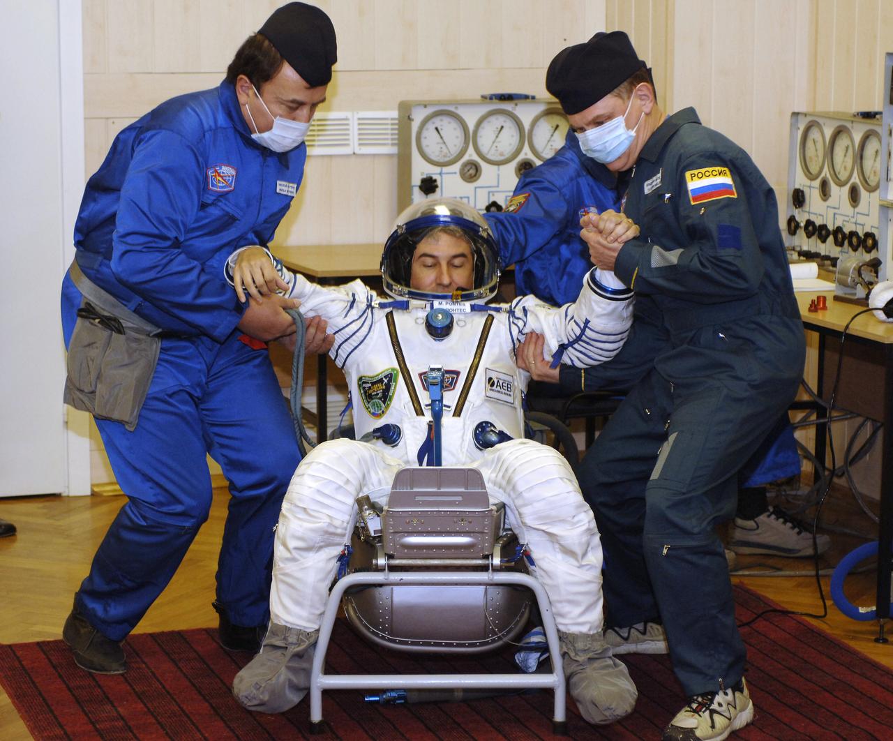Technicians check suit pressure for Brazilian Space Agency Soyuz crew member Marcos Pontes prior to launch onboard the Soyuz spacecraft from Baikonur, Kazakhstan, Thursday, March 30. 2006. Photo Credit: (NASA/Bill Ingalls)