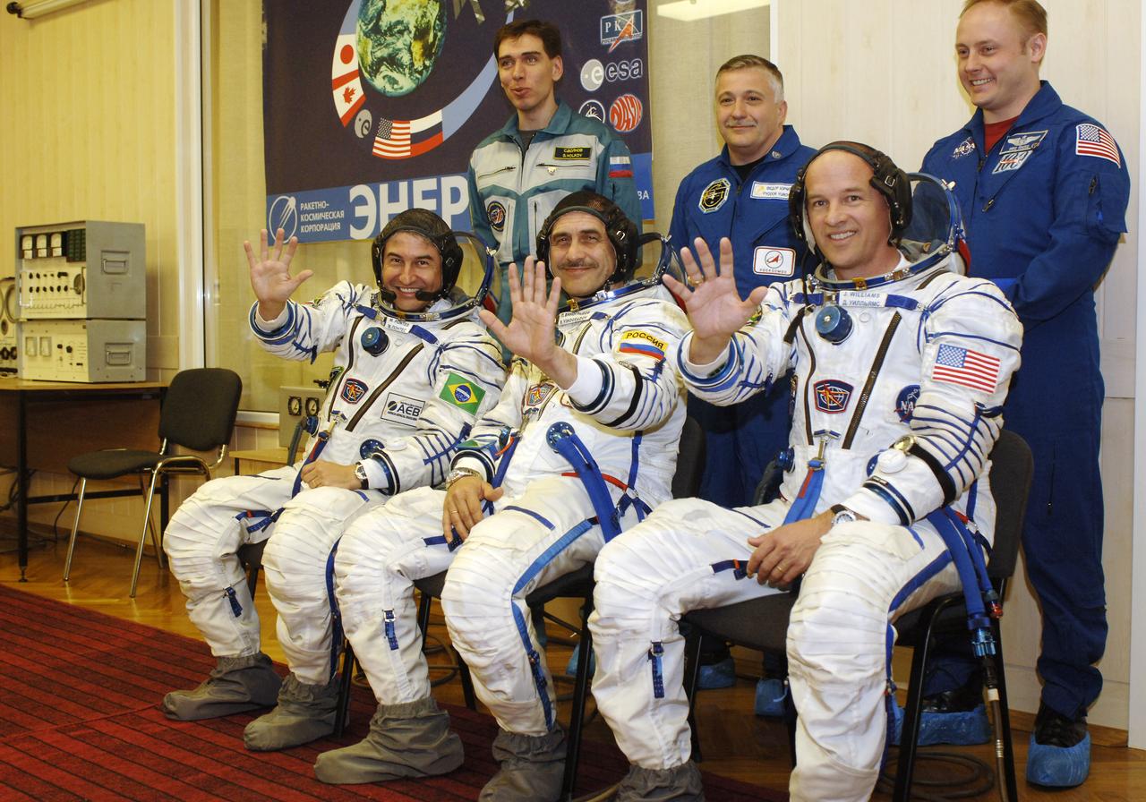 Prime and backup crew members for the upcoming mission to the International Space Station wave at the camera at Baikonur Cosmodrome during the final pressure checks of their suits. Backup crew: Sergei Volkov, standing left, Russia’s Federal Space Agency Soyuz crew member; Fyodor N. Yurchikhin, Commander; and Edward M. (Mike) Fincke, standing right, Science Officer and Flight Engineer. Prime crew: Marcos Pontes, seated left, Brazilian Space Agency Soyuz crew member; Expedition 13 crew members Pavel V. Vinogradov, Commander, and Jeffrey N. Williams, seated right, Science Officer and Flight Engineer. Baikonur, Kazakhstan. Thursday, March 30, 2006. Photo Credit: (NASA/Bill Ingalls)