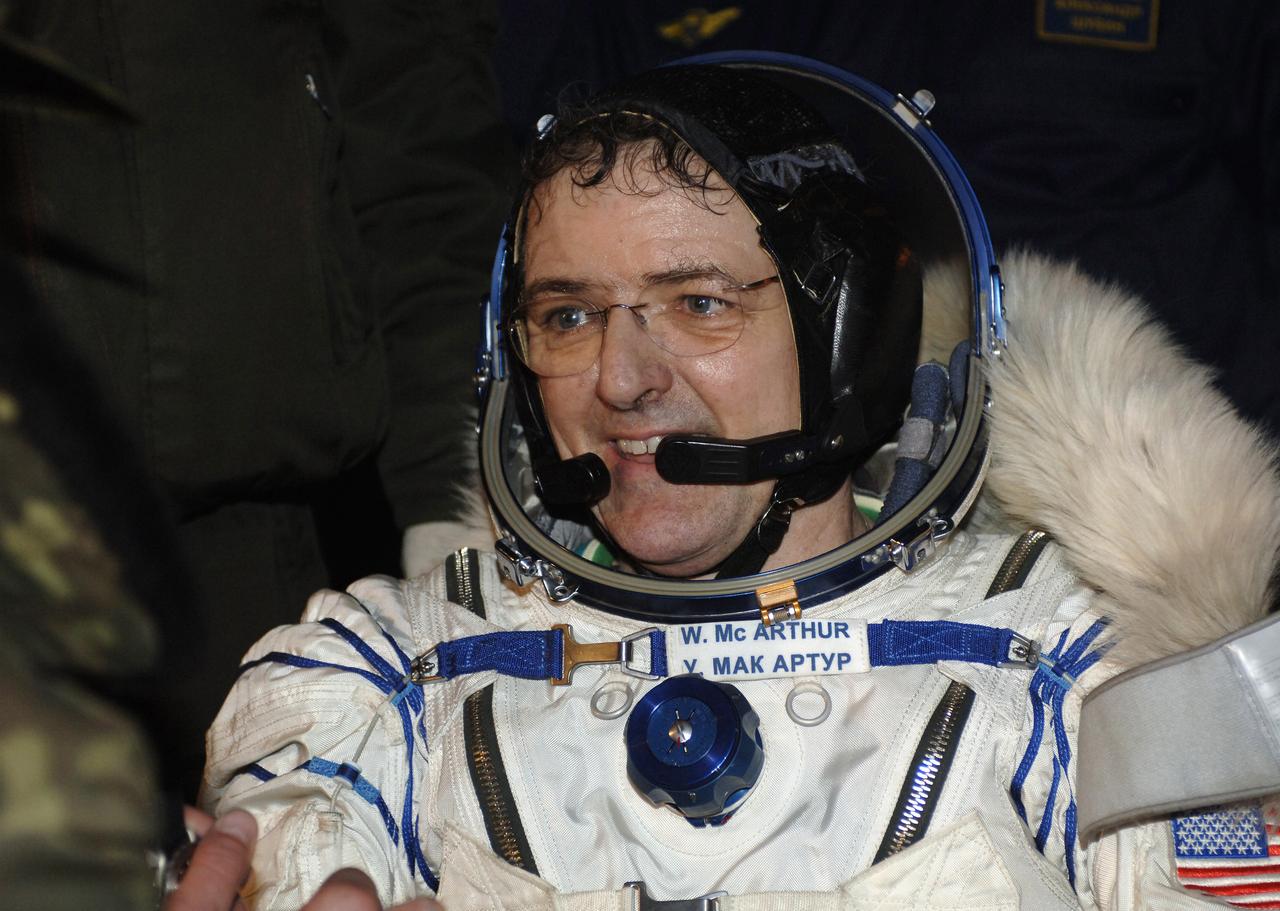 Astronaut William S. McArthur Jr., Expedition 12 commander and space station science officer, smiles as he experiences terra firma for the first time in six months following the touchdown of the Soyuz TMA-7 spacecraft in the steppes of Kazakhstan, Sunday, April 9, 2006. Brazilian astronaut Marcos Pontes and cosmonaut Valery I. Tokarev, Russias Federal Space Agency flight engineer and Soyuz commander joined McArthur for the return trip from the orbital outpost. Photo Credit: (NASA/Bill Ingalls)