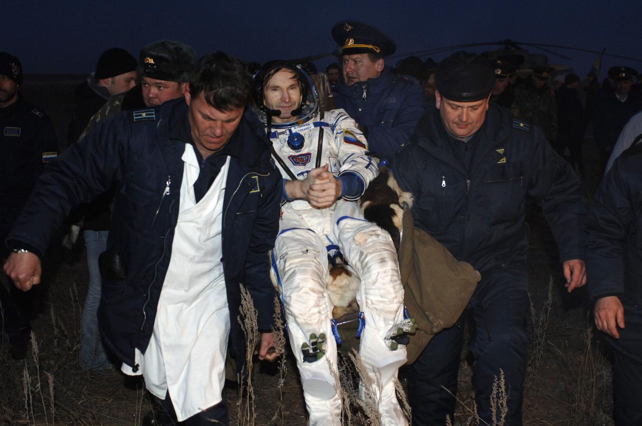 Valery I. Tokarev, Russia’s Federal Space Agency Flight Engineer and Soyuz Commander; sees more people than he's seen in six months as personnel assist him in egressing his Soyuz spacecraft. Tokarev and William S. McArthur, Jr., NASA Commander and International Space Station Science Officer; along with Marcos C. Pontes representing the Brazilian Space Agency, returned to Earth onboard the Soyuz TMA-7 spacecraft. Touch down was on Sunday, April 9, 2006, in the steppes of Kazakhstan. Pontes arrived at the station with the Expedition 13 crew on April 1. Photo Credit: (NASA/Bill Ingalls)