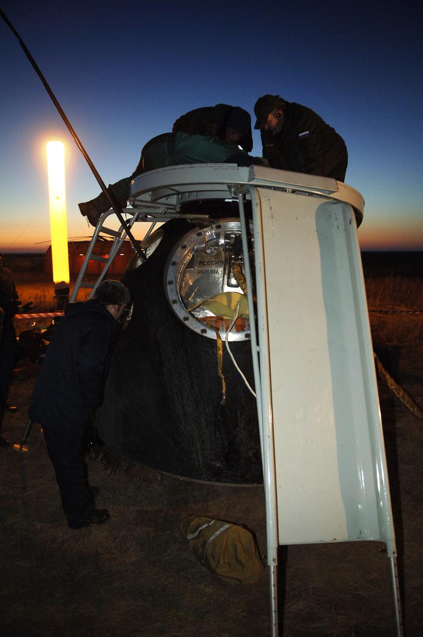 Workers prepare to open the hatch of the Soyuz TMA-7 spacecraft moments after its touchdown in the steppes of Kazakhstan, Sunday, April 9, 2006. Inside were Commander and International Space Station Science Officer, William S. McArthur Jr.; Russia’s Federal Space Agency Flight Engineer and Soyuz Commander, Valery I. Tokarev and Brazil’s first astronaut in space, Marcos C. Pontes representing the Brazilian Space Agency. Photo Credit: (NASA/Bill Ingalls)