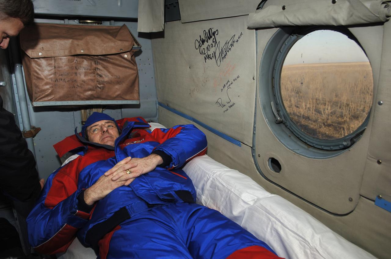 Expedition 12 Commander Bill McArthur rest onboard a Russian helicopter that will take him from the landing site to Kustanay, Kazakhstan. Expedition 12 returned to Earth and landed in the steppes of Kazakhstan onboard a Soyuz TMA-7 spacecraft that touched down at 7:48 p.m. EDT on Sunday, April 9, 2006. Returning with Commander Bill McArthur and Flight Engineer Valery Tokarev was Brazil’s first astronaut, Marcos Pontes, who arrived at the station with Expedition 13 on April 1.   Photo Credit: (NASA/Bill Ingalls)