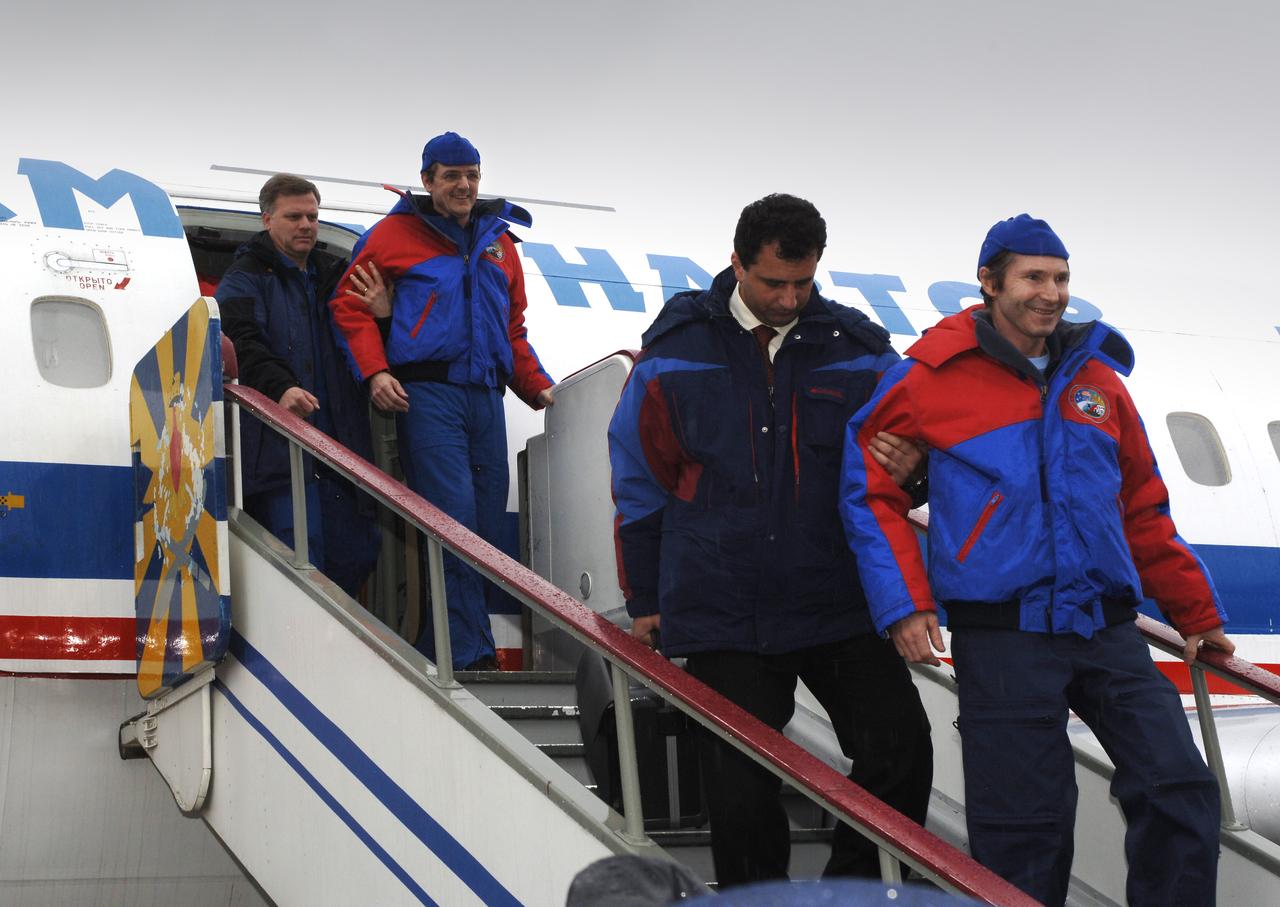 Astronaut William S. (Bill) McArthur, Jr., left, Expedition 12 Commander and space station Science Officer; Valery I. Tokarev, Flight Engineer and Soyuz commander; are helped from a plane after their landing. The Expedition 12 crew brought their Soyuz TMA-7 capsule to a pre-dawn landing on Sunday, April 9, 2006 at 7:48 p.m. EDT. Photo Credit: (NASA/Bill Ingalls)