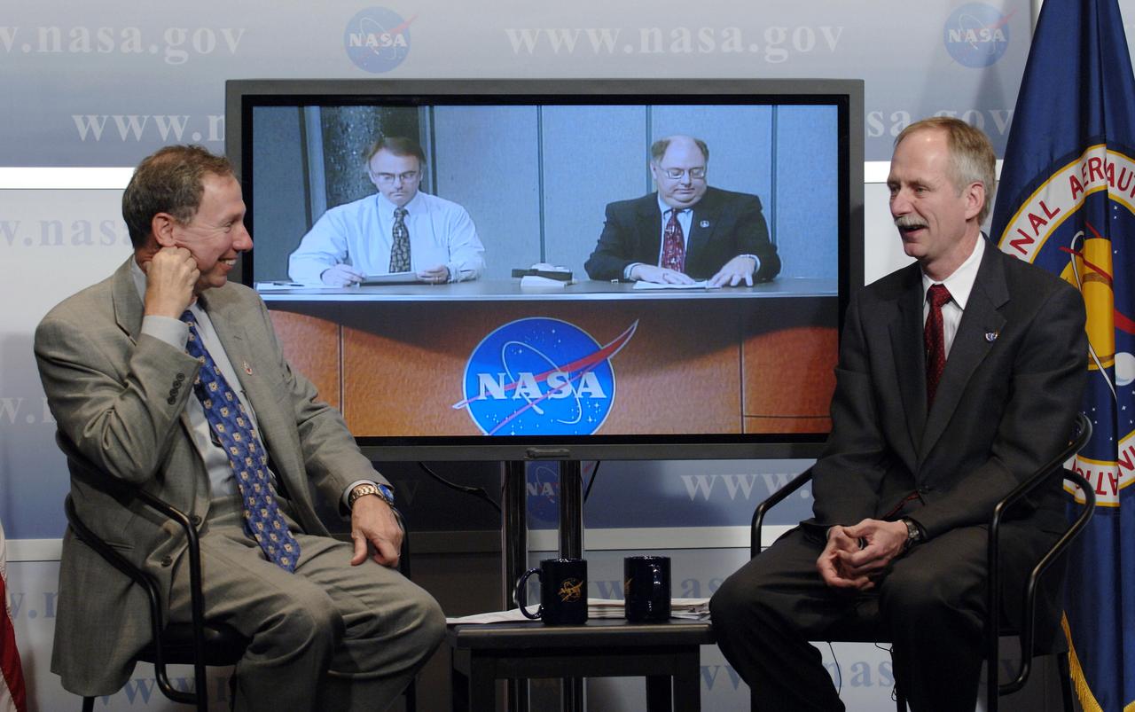 NASA Administrator Michael Griffin, left, and Associate Administrator for Space Operations William Gerstenmaier, right, smile as Space Shuttle Program Manager Wayne Hale, right on television screen, and Ken Welzyn, External Tank Chief Engineer, join in from NASA's Marshall Space Flight Center during a media briefing about the space shuttle program and processing for the STS-121 mission, Friday, April 28, 2006, at NASA Headquarters in Washington. Photo Credit (NASA/Bill Ingalls)