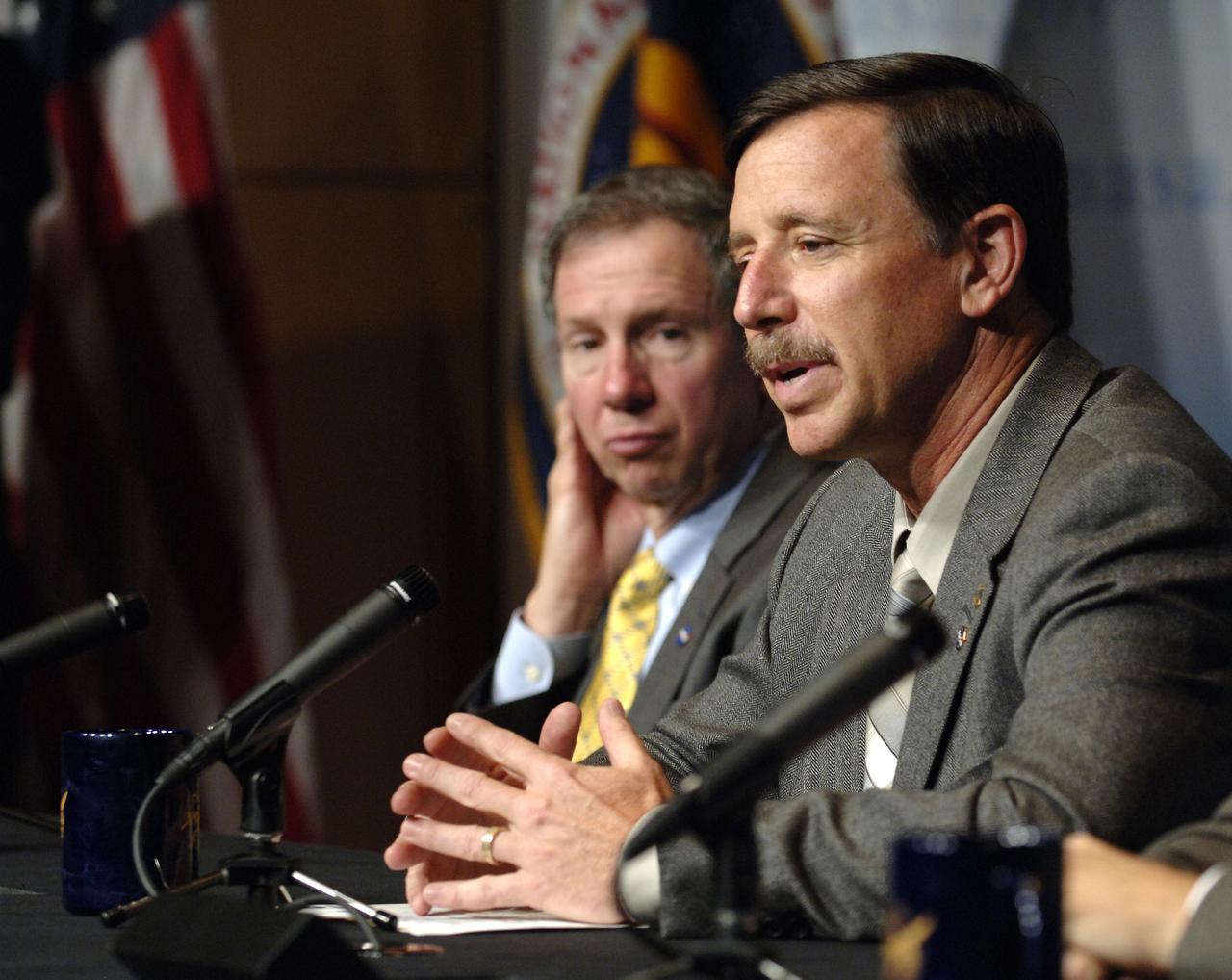 NASA Administrator Michael Griffin, left, looks on as Scott Horowitz, NASA Associate Administrator for Exploration Systems speaks during a press conference outlining specific center responsibilities associated with the Constellation Program for robotic and human Moon and Mars exploration, Monday, June 5, 2006, at NASA Headquarters in Washington.  Photo Credit (NASA/Bill Ingalls)