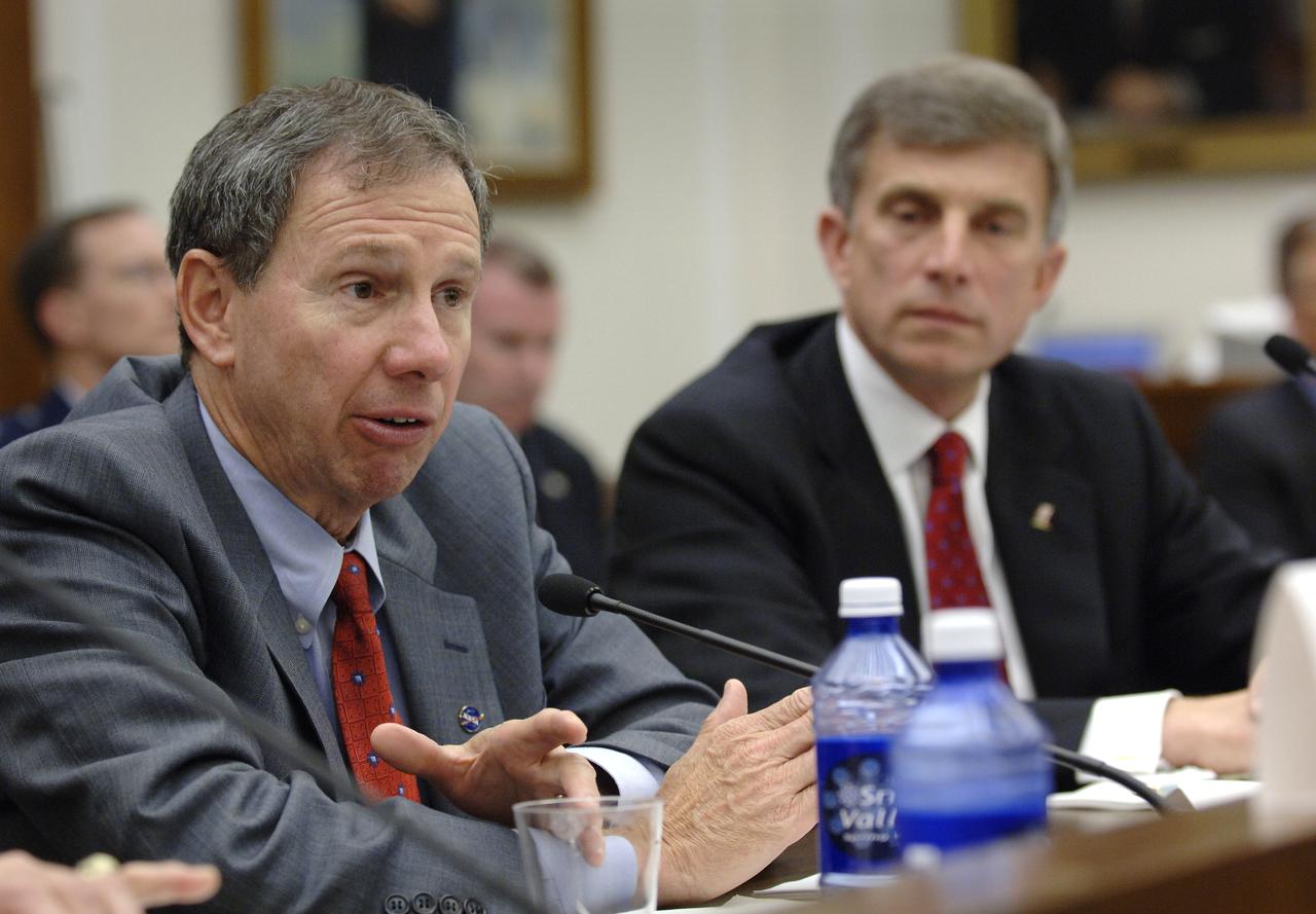 NASA Administrator Michael Griffin, left, testifies before the House Committee on Science and Technology regarding the future of the National Polar-orbiting Operational Environmental Satellite System (NPOESS) and results of the Nunn-McCurdy review of NOAA’s weather satellite program, as Under Secretary of the Air Force Dr. Ronald Sega looks on, Thursday, June 8, 2006, at the Rayburn House Office Building in Washington. Photo Credit: (NASA/Bill Ingalls)