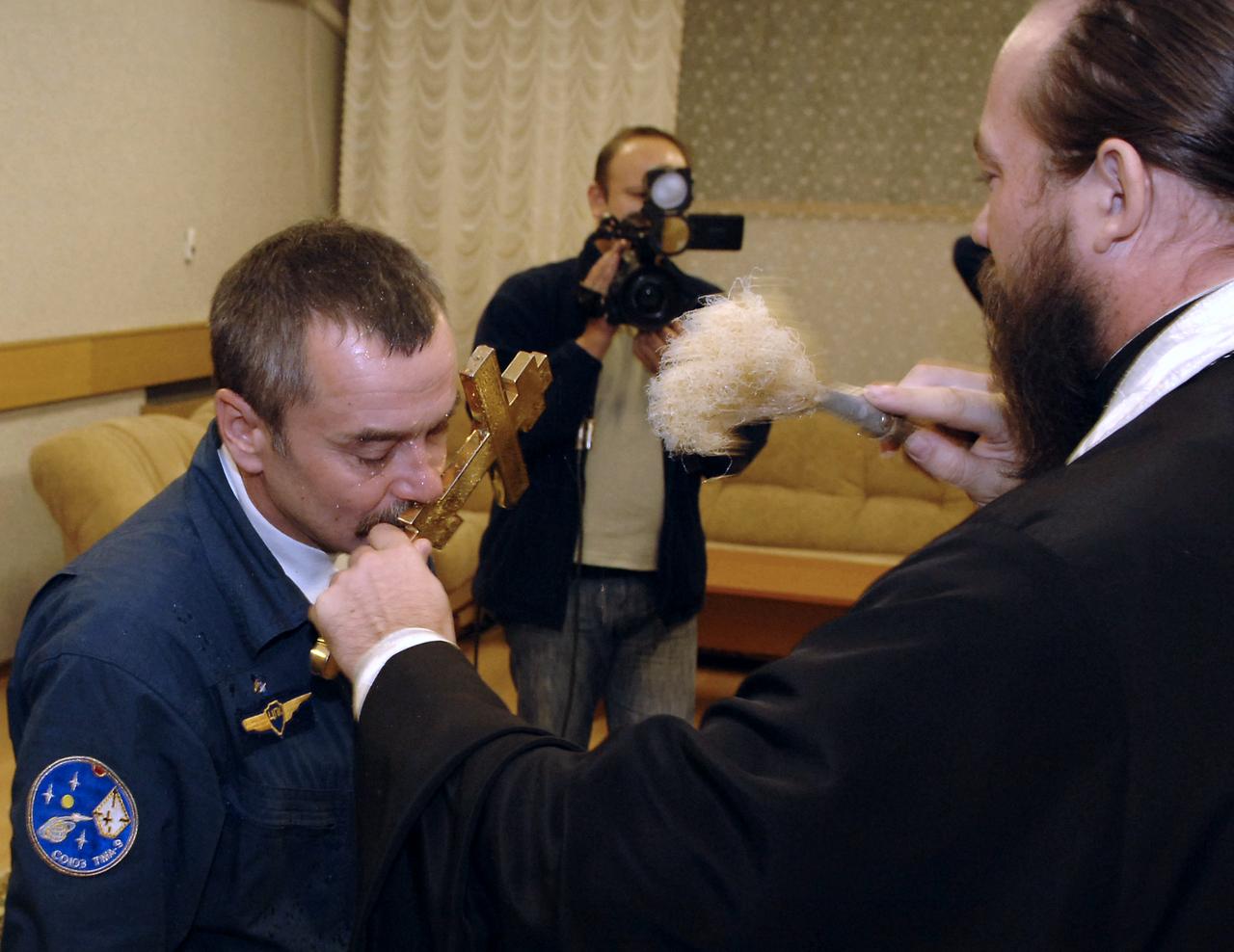 Soyuz Commander and Expedition 14 Flight Engineer Mikhail Tyurin receives a blessing at the Cosmonaut Hotel the morning of his launch onboard the Soyuz TMA-9 spacecraft, Monday, Sept. 18, 2006, in Baikonur, Kazakhstan. The Soyuz TMA-9 spacecraft launched from the Baikonur Cosmodrome in carrying Expedition 14 Commander Michael Lopez-Alegria, Soyuz Commander and Expedition 14 Flight Engineer Mikhail Tyurin and American spaceflight participant Anousheh Ansari to the International Space Station. Anousheh Ansari will spend nine days on the station under a commercial agreement with the Russian Federal Space Agency. Photo Credit: (NASA/Bill Ingalls)