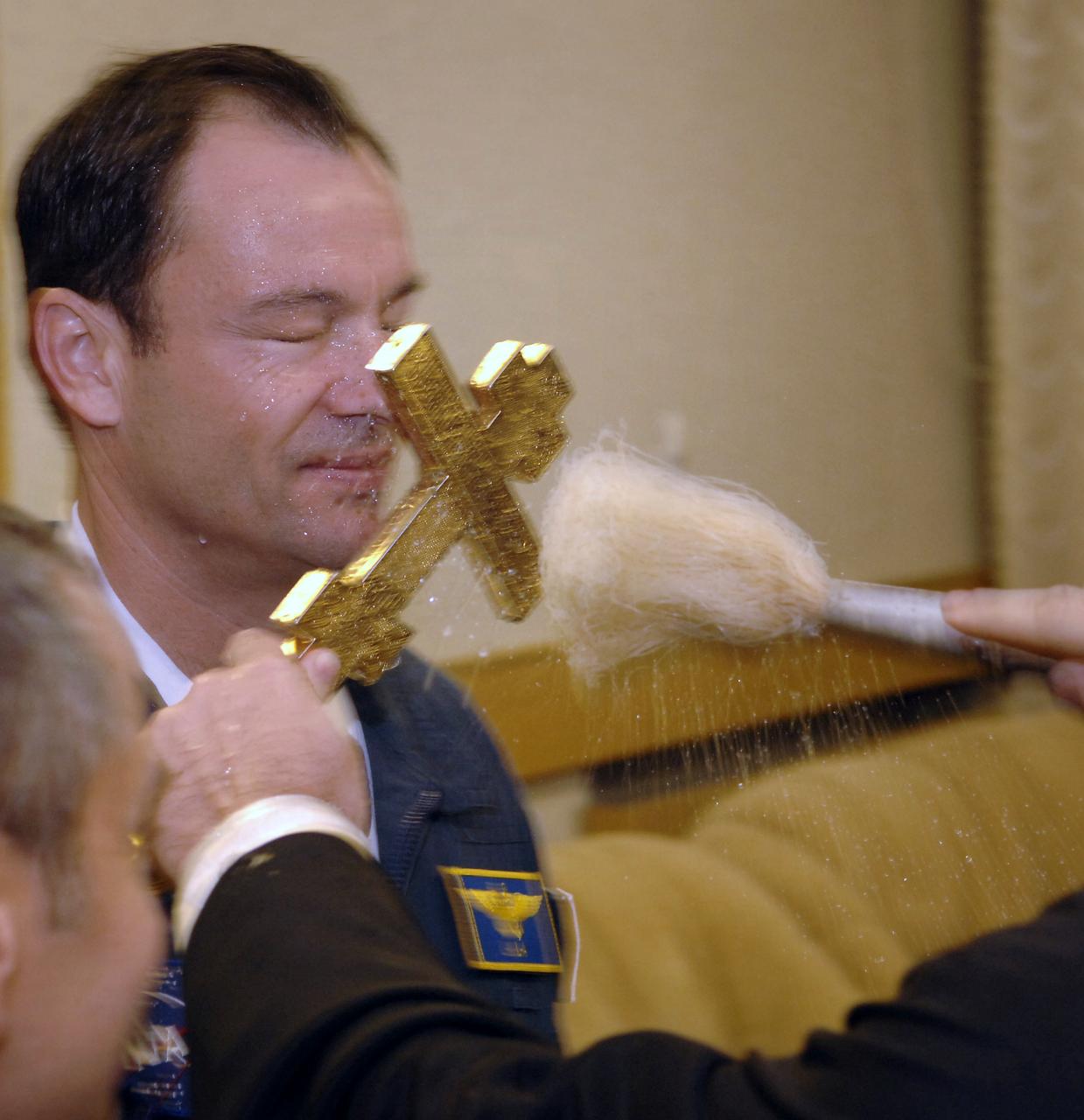 Expedition 14 Commander Michael Lopez-Alegria receives a blessing at the Cosmonaut Hotel the morning of his launch onboard the Soyuz TMA-9 spacecraft, Monday, Sept. 18, 2006 in Baikonur, Kazakhstan. The Soyuz TMA-9 spacecraft launched from the Baikonur Cosmodrome carrying Expedition 14 Commander Michael Lopez-Alegria, Soyuz Commander and Expedition 14 Flight Engineer Mikhail Tyurin and American spaceflight participant Anousheh Ansari, who will spend nine days on the International Space Station under a commercial agreement with the Russian Federal Space Agency. Photo Credit: (NASA/Bill Ingalls)