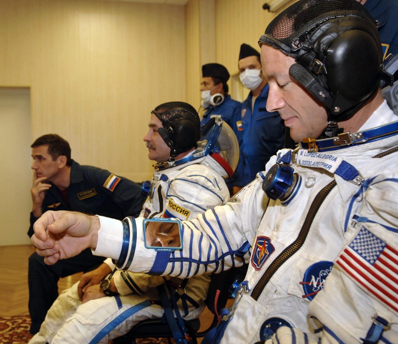 Expedition 14 Commander Michael Lopez-Alegria, right, and Soyuz Commander and Expedition 14 Flight Engineer Mikhail Tyurin don their Russian Sokol suits the Baikonur Cosmodrome prior to launch, Monday, Sept. 18, 2006, in Kazakhstan. The Soyuz TMA-9 spacecraft launched from the Baikonur Cosmodrome at 10:09 a.m. local time carrying Expedition 14 Commander Michael Lopez-Alegria, Soyuz Commander and Expedition 14 Flight Engineer Mikhail Tyurin and American spaceflight participant Anousheh Ansari, who will spend nine days on the International Space Station under a commercial agreement with the Russian Federal Space Agency. Photo Credit: (NASA/Bill Ingalls)