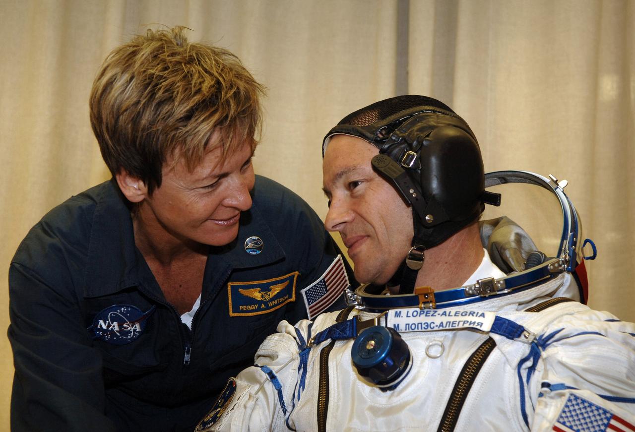 Expedition 14 Commander Michael Lopez-Alegria, right, having donned his Russian Sokol suit at the Baikonur Cosmodrome, takes a moment to talk with Expedition 14 backup crew member Peggy Whitson, Monday, Sept. 18, 2006, in Kazakhstan. The Soyuz TMA-9 spacecraft launched from the Baikonur Cosmodrome at 10:09 a.m. local time carrying Expedition 14 Commander Michael Lopez-Alegria, Soyuz Commander and Expedition 14 Flight Engineer Mikhail Tyurin and American spaceflight participant Anousheh Ansari, who will spend nine days on the International Space Station under a commercial agreement with the Russian Federal Space Agency. Photo Credit: (NASA/Bill Ingalls)