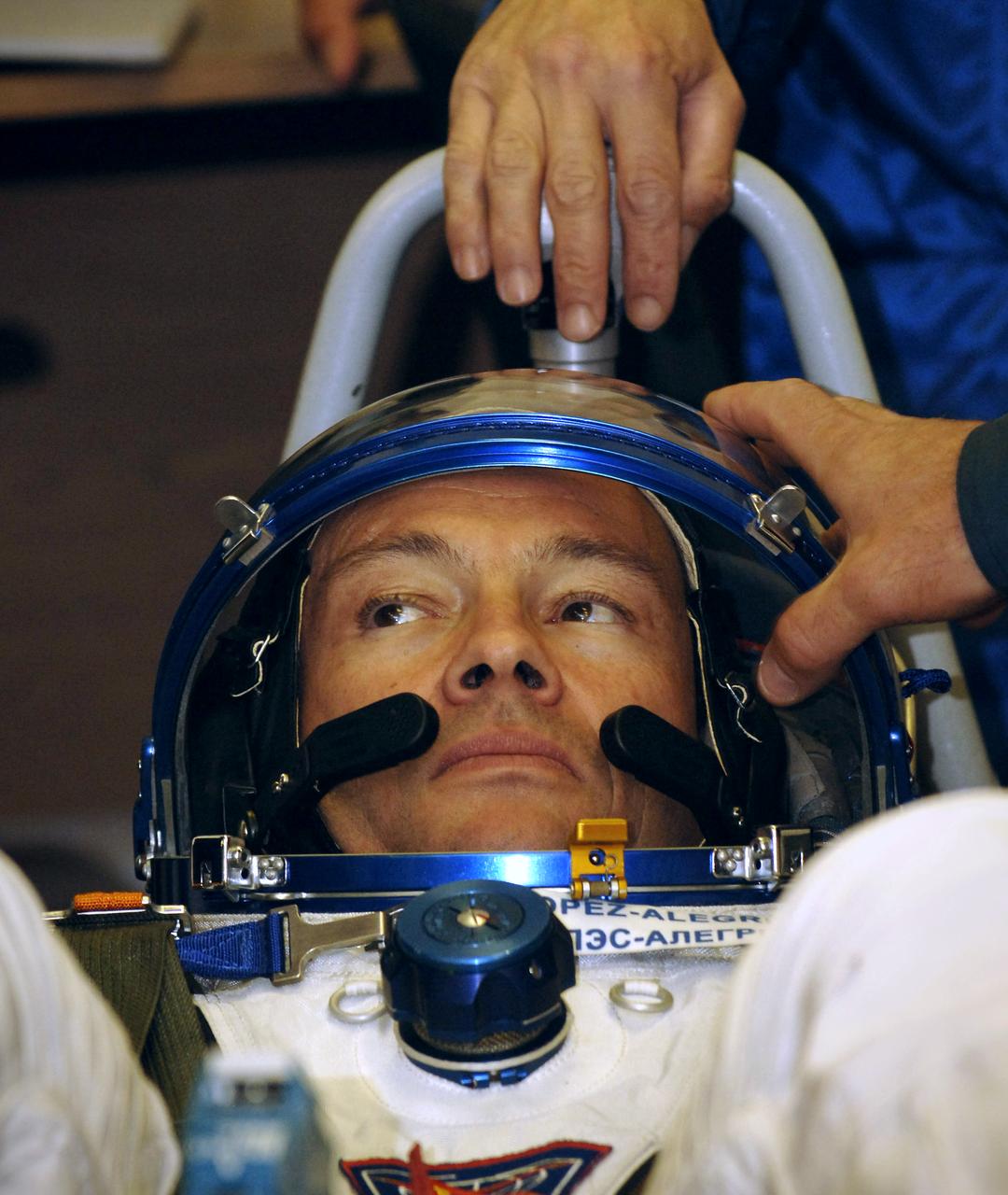 Expedition 14 Commander Michael Lopez-Alegria prepares for pressure checks on his Russian Sokol suit at the Baikonur Cosmodrome, Monday, Sept. 18, 2006, in Kazakhstan.  The Soyuz TMA-9 spacecraft launched from the Baikonur Cosmodrome at 10:09 a.m. local time carrying Expedition 14 Commander Michael Lopez-Alegria, Soyuz Commander and Expedition 14 Flight Engineer Mikhail Tyurin and American spaceflight participant Anousheh Ansari, who will spend nine days on the International Space Station under a commercial agreement with the Russian Federal Space Agency.  Photo Credit: (NASA/Bill Ingalls)