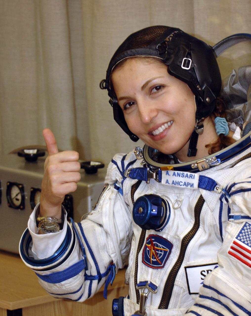 American spaceflight participant Anousheh Ansari gives a thumbs up as she prepares for pressure checks on her Russian Sokol suit at the Baikonur Cosmodrome, Monday, Sept. 18, 2006, in Kazakhstan. The Soyuz TMA-9 spacecraft launched from the Baikonur Cosmodrome at 10:09 a.m. local time carrying Expedition 14 Commander Michael Lopez-Alegria, Soyuz Commander and Expedition 14 Flight Engineer Mikhail Tyurin and American spaceflight participant Anousheh Ansari, who will spend nine days on the International Space Station under a commercial agreement with the Russian Federal Space Agency. Photo Credit: (NASA/Bill Ingalls)