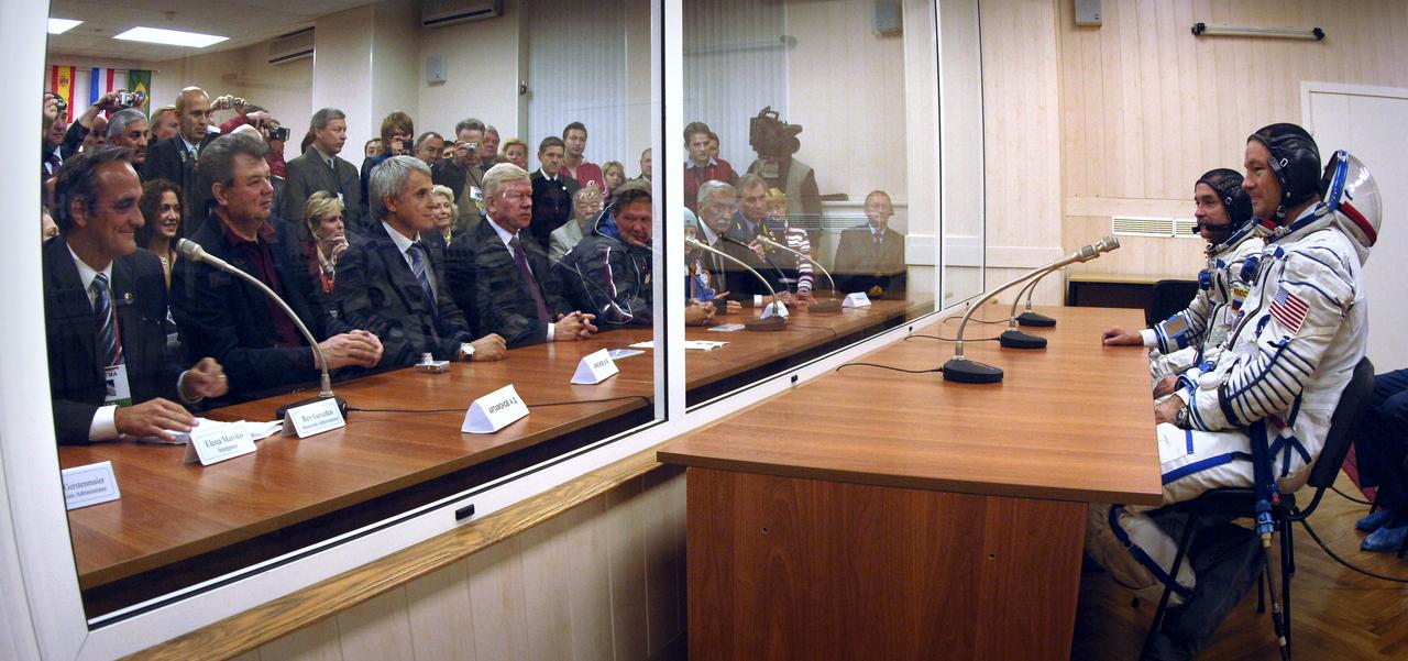 Expedition 14 Commander Michael Lopez-Alegria, far right, Soyuz Commander and Expedition 14 Flight Engineer Mikhail Tyurin, second from right, American spaceflight participant Anousheh Ansari, not pictured, and their backup crew meet with Russian and American officials moments before boarding the bus to head to the Soyuz launch pad, Monday, Sept. 18, 2006, in Baikonur, Kazakhstan. The Soyuz TMA-9 spacecraft launched from the Baikonur Cosmodrome at 10:09 a.m. local time. Anousheh Ansari will spend nine days on the International Space Station under a commercial agreement with the Russian Federal Space Agency. Photo Credit: (NASA/Bill Ingalls)