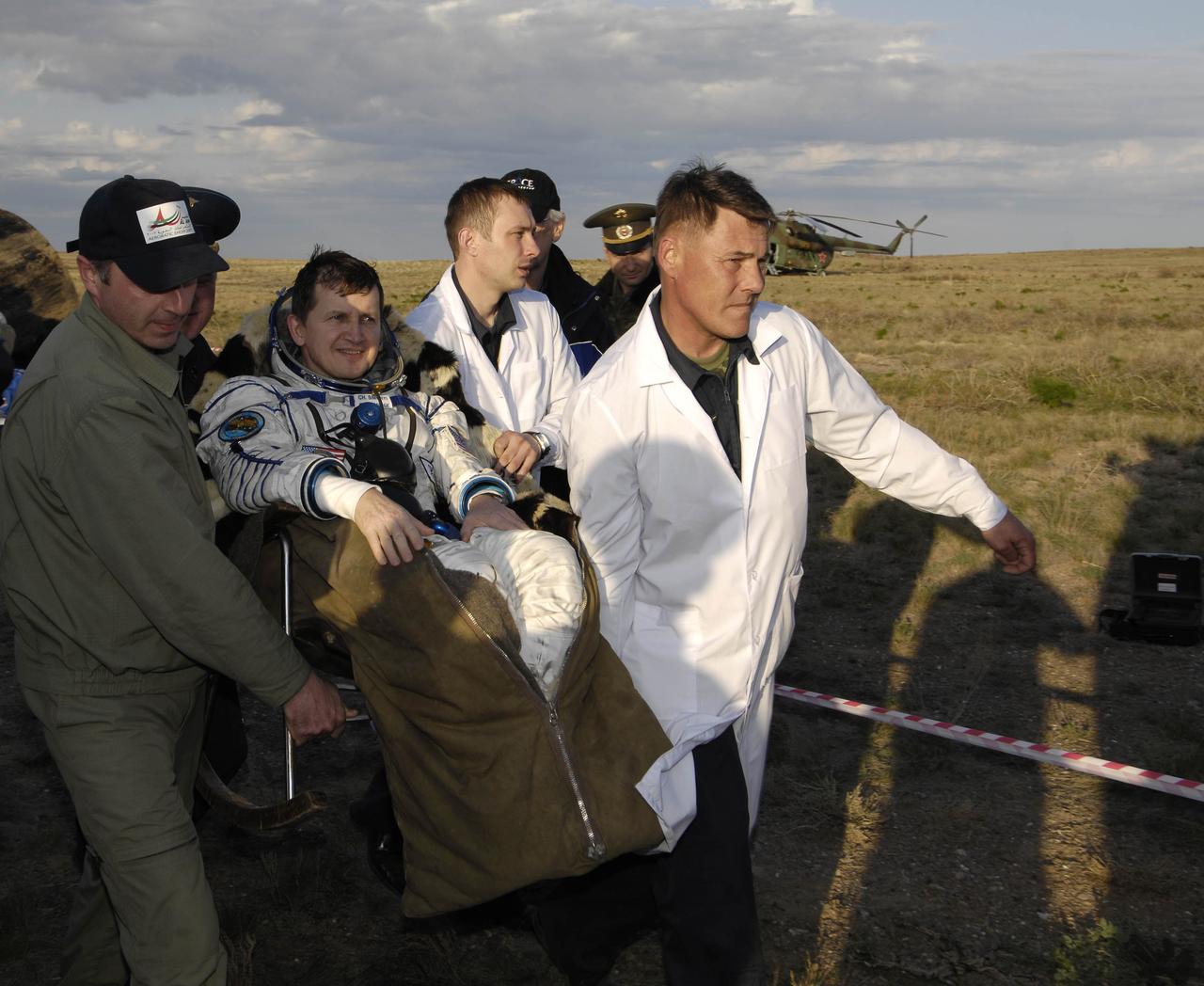 American spaceflight participant Charles Simonyi is taken in his chair to the medical tent near the Soyuz TMA-9 spacecraft where the recovery officials conduct post-landing medical checks, Friday, April 21, 2007 in Kazakhstan. Expedition 14 Commander Michael Lopez-Alegria, Flight Engineer Mikhail Tyurin and American spaceflight participant Charles Simonyi landed in their Soyuz TMA-9 spacecraft southwest of Karaganda, Kazakhstan at approximately 6:30 p.m. local time. Photo Credit: (NASA/Bill Ingalls)