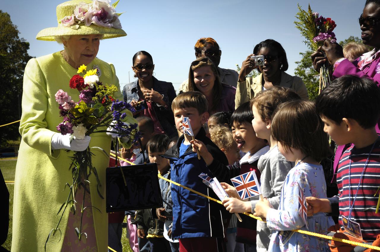 Queen Elizabeth II greets children on her walk from NASA’s Goddard Space Flight Center mission control to a reception in the center’s main auditorium, Tuesday, May 8, 2007, in Greenbelt, Md.  Queen Elizabeth II and her husband, Prince Philip, Duke of Edinburgh, visited the NASA Goddard Space Flight Center as one of the last stops on their six-day United States visit. Photo Credit: (NASA/Bill Ingalls)
