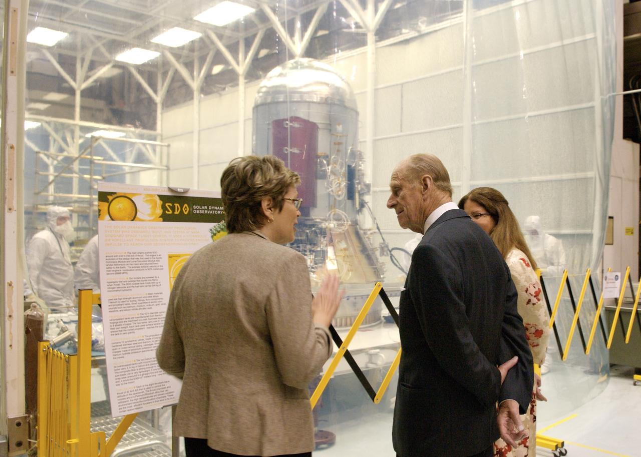 Solar Dynamics Observatory Program Manager, left, describes the SDO project to Prince Philip in front of the spacecraft clean tent.  Photo Credit: (NASA/Chris Gunn)